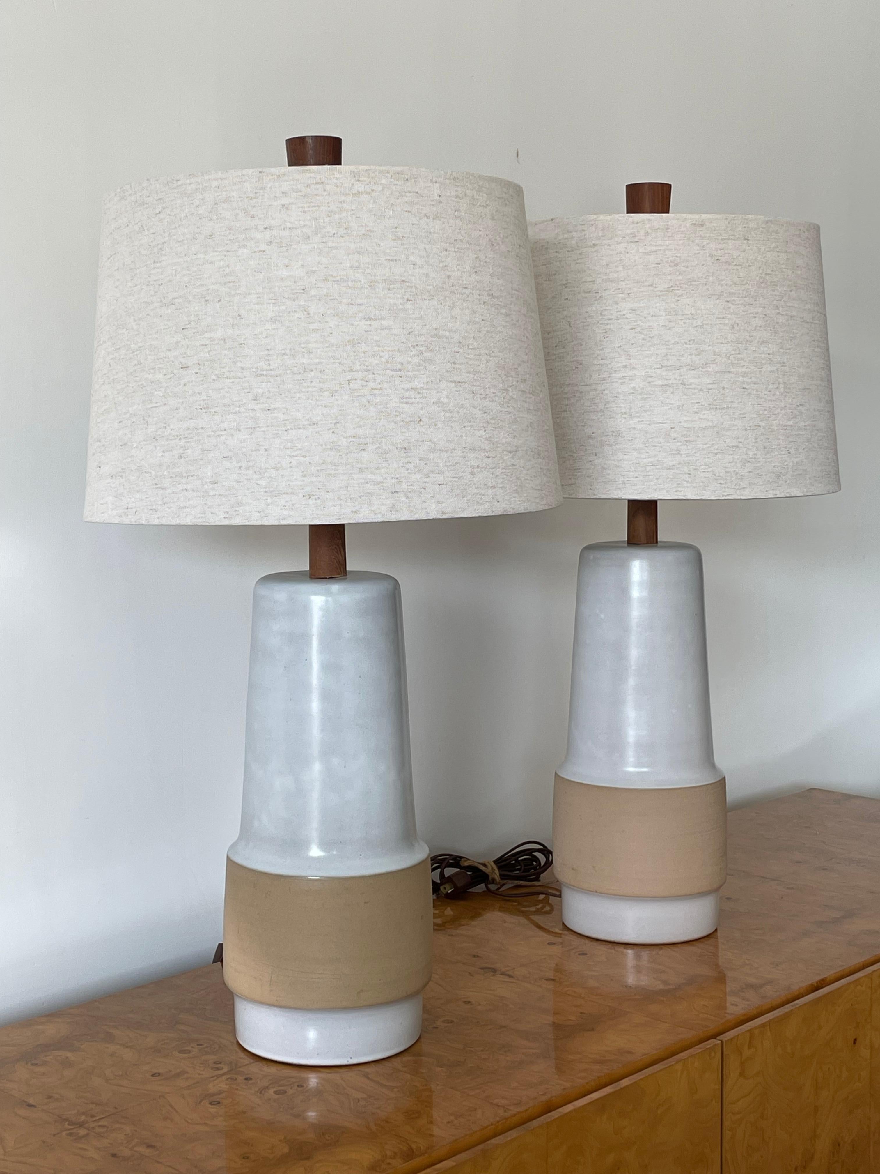 A pair of large table lamps by famed ceramicist duo Jane and Gordon Martz for Marshall Studios. White flat glaze with bisque mid section. 

Measures: overall 
28.5” tall
15” wide

Ceramic 
15” tall
6.75” wide.