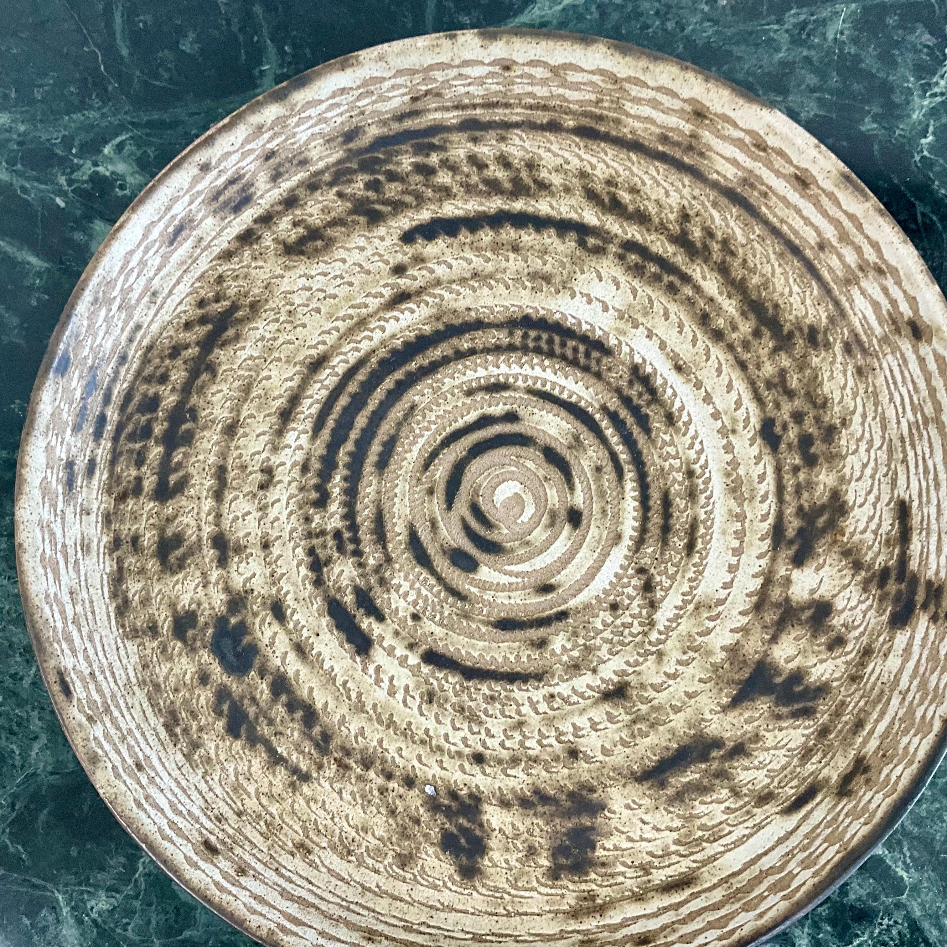 Pottery charger plate in cream and brown by artist Gordon and Jane Martz for Marshall Studios.  Executed in the 1950’s this piece measures 13” in diameter and 1.5” high.


BIOGRAPHY
Gordon Martz married Jane Marshall soon after graduating from