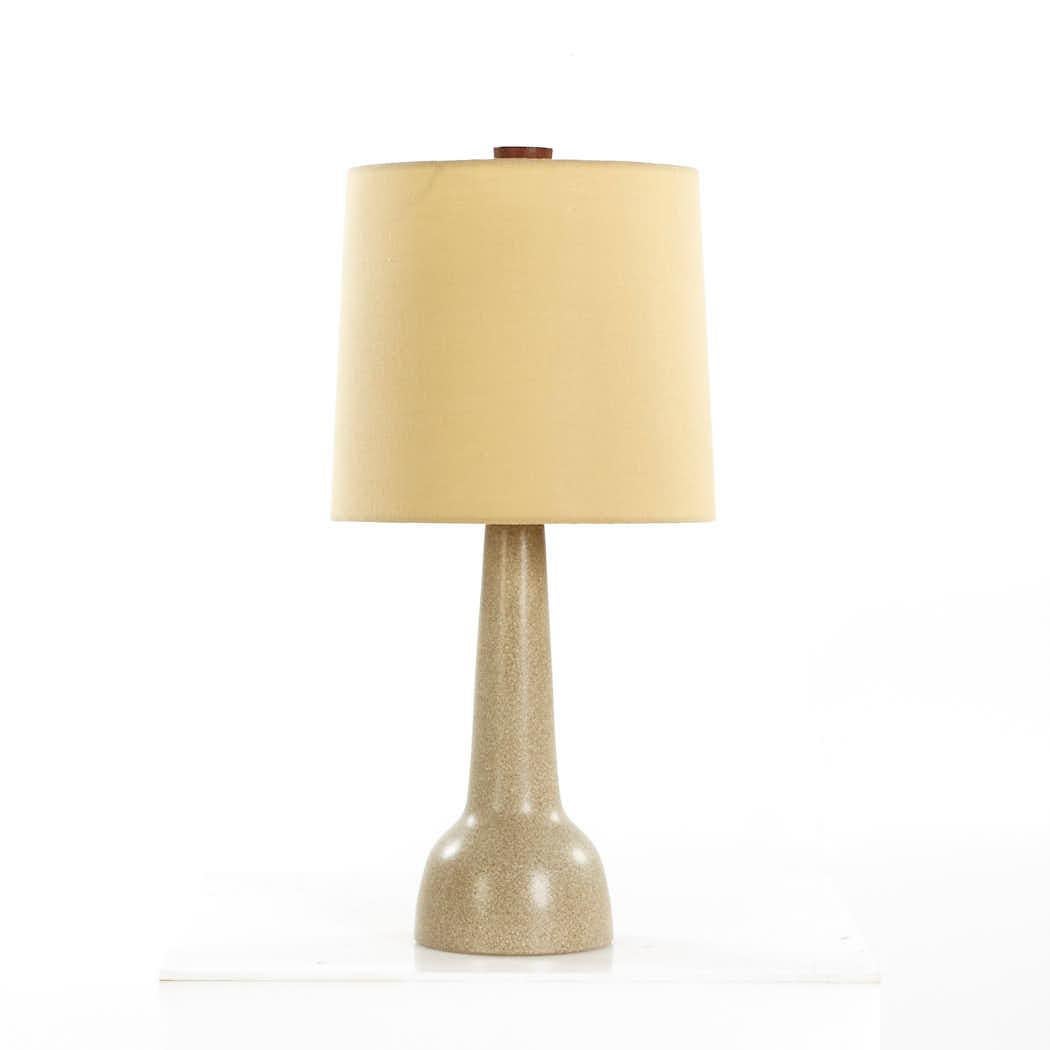 Jane and Gordon Martz Mid Century Walnut and Ceramic Lamp

This table lamp measures: 11 wide x 11 deep x 22.5 inches high

We take our photos in a controlled lighting studio to show as much detail as possible. We do not photoshop out blemishes. 

We