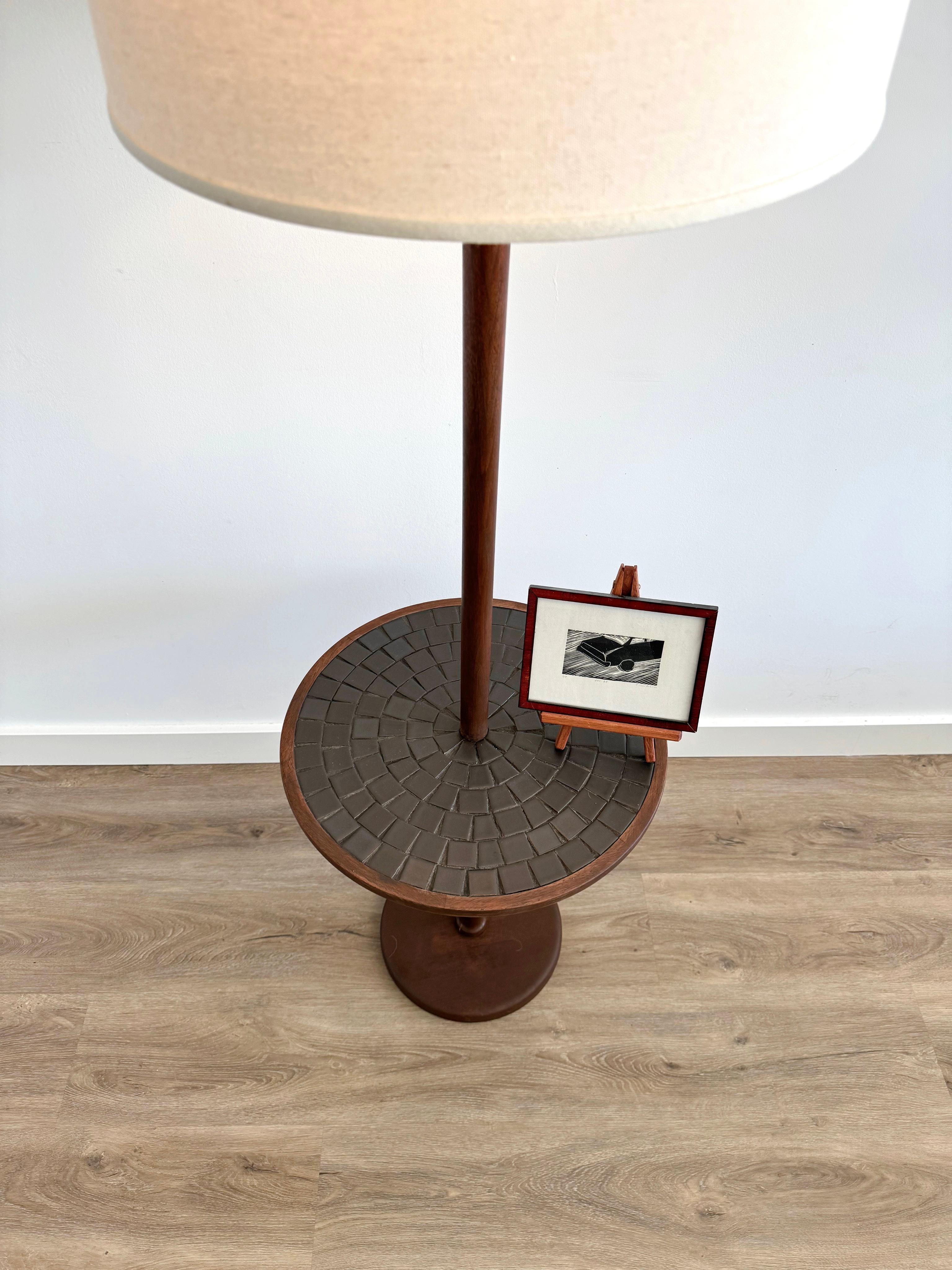 Table floor lamp by Jane and Gordon Marts for marshall studios. 
This beauty stands with its walnut base featuring its black mosaic tiled top.
Finial is pretty damaged but otherwise in great working condition. It is quite the versatile floor lamp.
