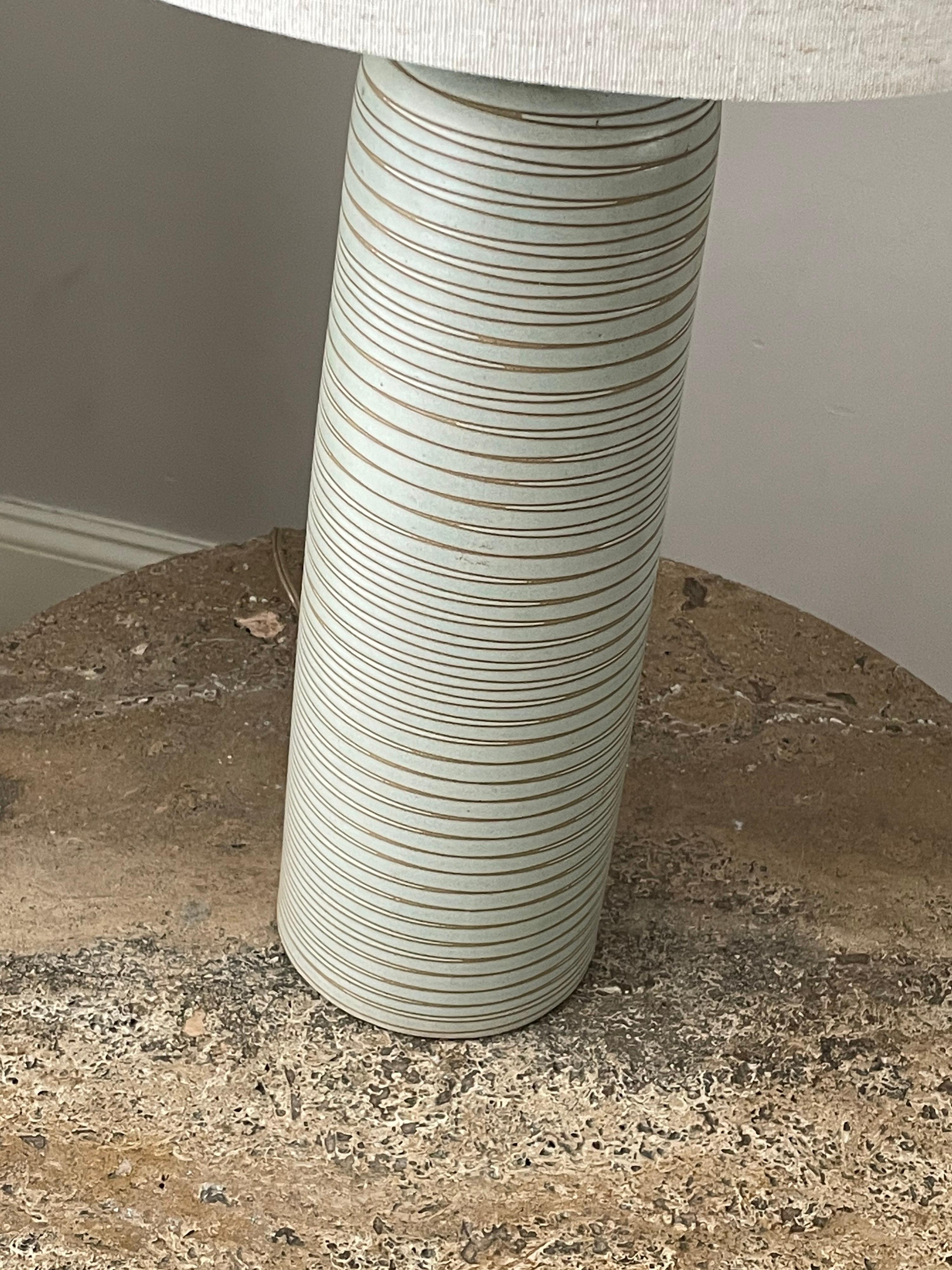 Tall table lamp designed by famed ceramicist duo Jane and Gordon Martz for Marshall Studios. Features a mint like color with bisque incised swirl. 

Dimensions:
29” tall
15” wide

Ceramic
15” tall 
5.25” wide.