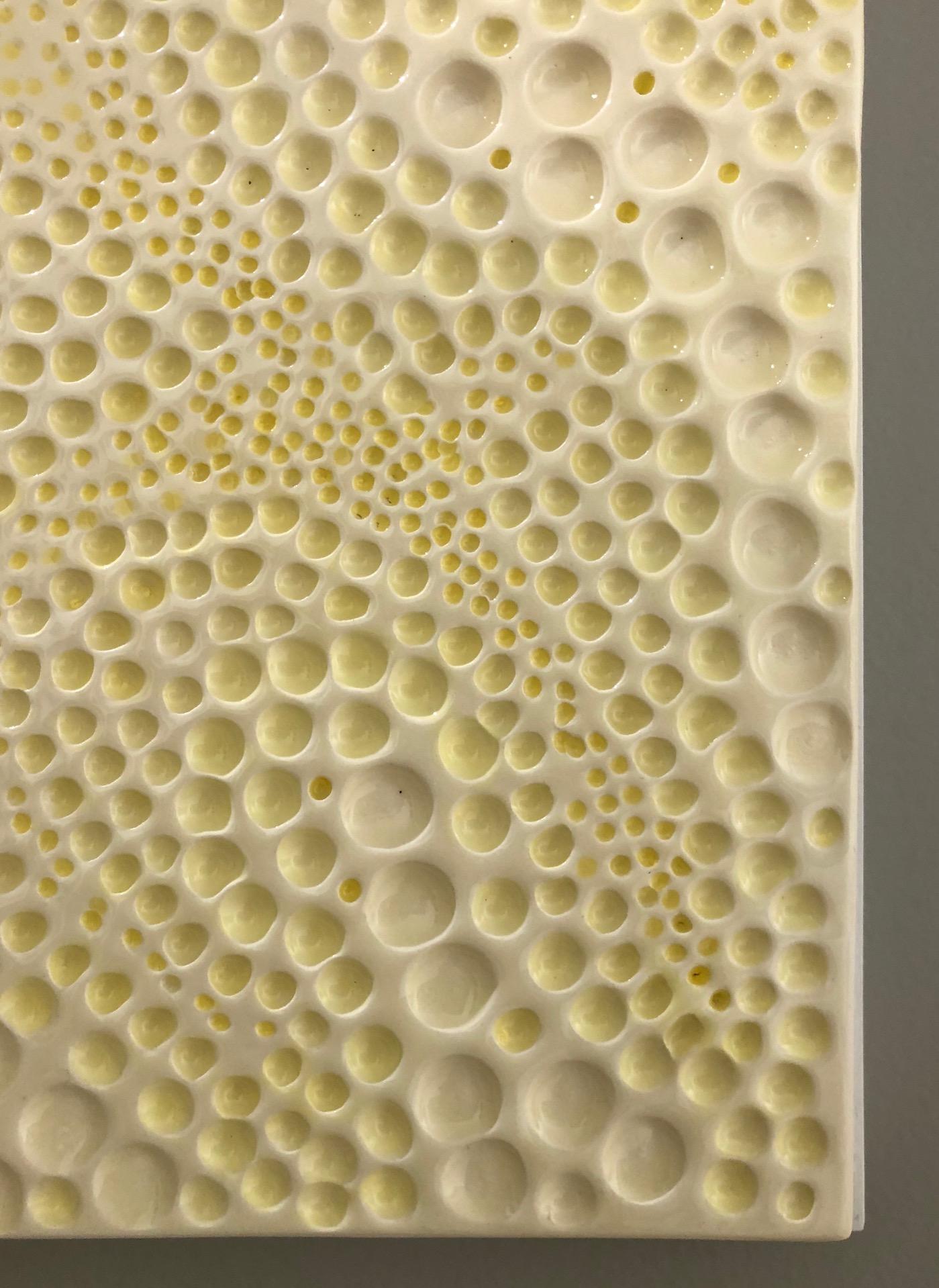 Ceramic abstract wall sculpture in yellow and white. A neutral in color - minimal, clean work created with low-fire ceramic over white wood from Pop Art pioneer Jane B. Grimm, whose minimal and meditative sculptures and wall reliefs are comprised of