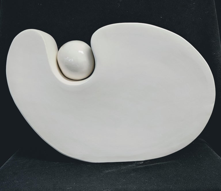 Jane B Grimm
Rhapsody VII, 2020
ceramic 15 x 21 x 5 in

White amorphic abstract sculpture with ball, created with hand formed ceramic. Dimensions are 15 x 21 x 5 inches. A wonderful ceramic sculpture by Jane B. Grimm who began her artistic career in