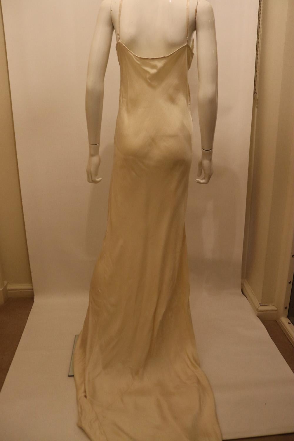 A stunning vintage slip gown by Jane Bourvis. The dress has a v neckline and puddle train at the back.
The dress is in wonderful fabric and hangs beautifully. Measurements : Bust up to 39'',length 72''