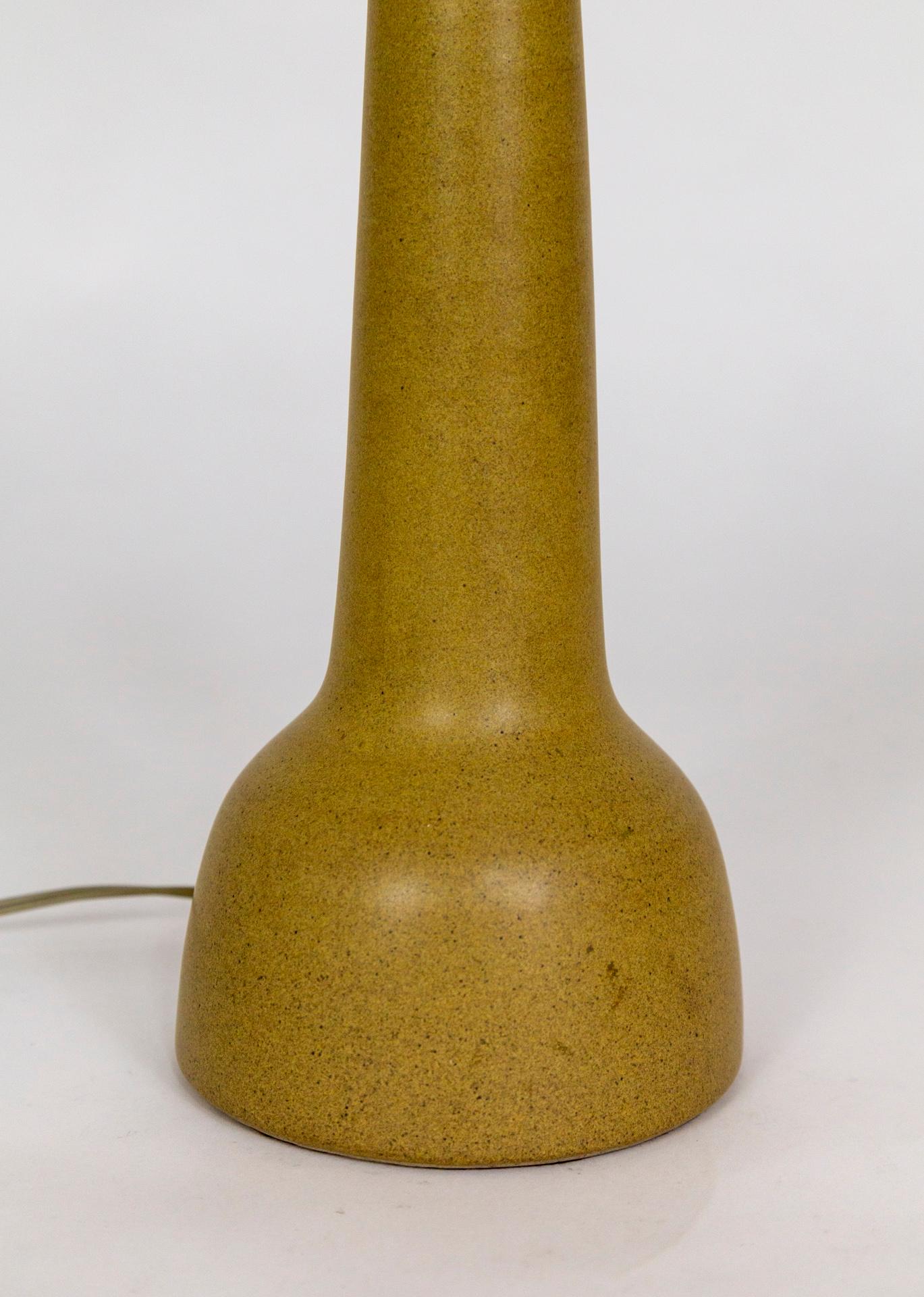 A streamlined, ceramic lamp, glazed in matte camel; made by Marshall Studios and designed by Jane and Gordon Martz, circa the 1960s. Signed on the back.  5.75