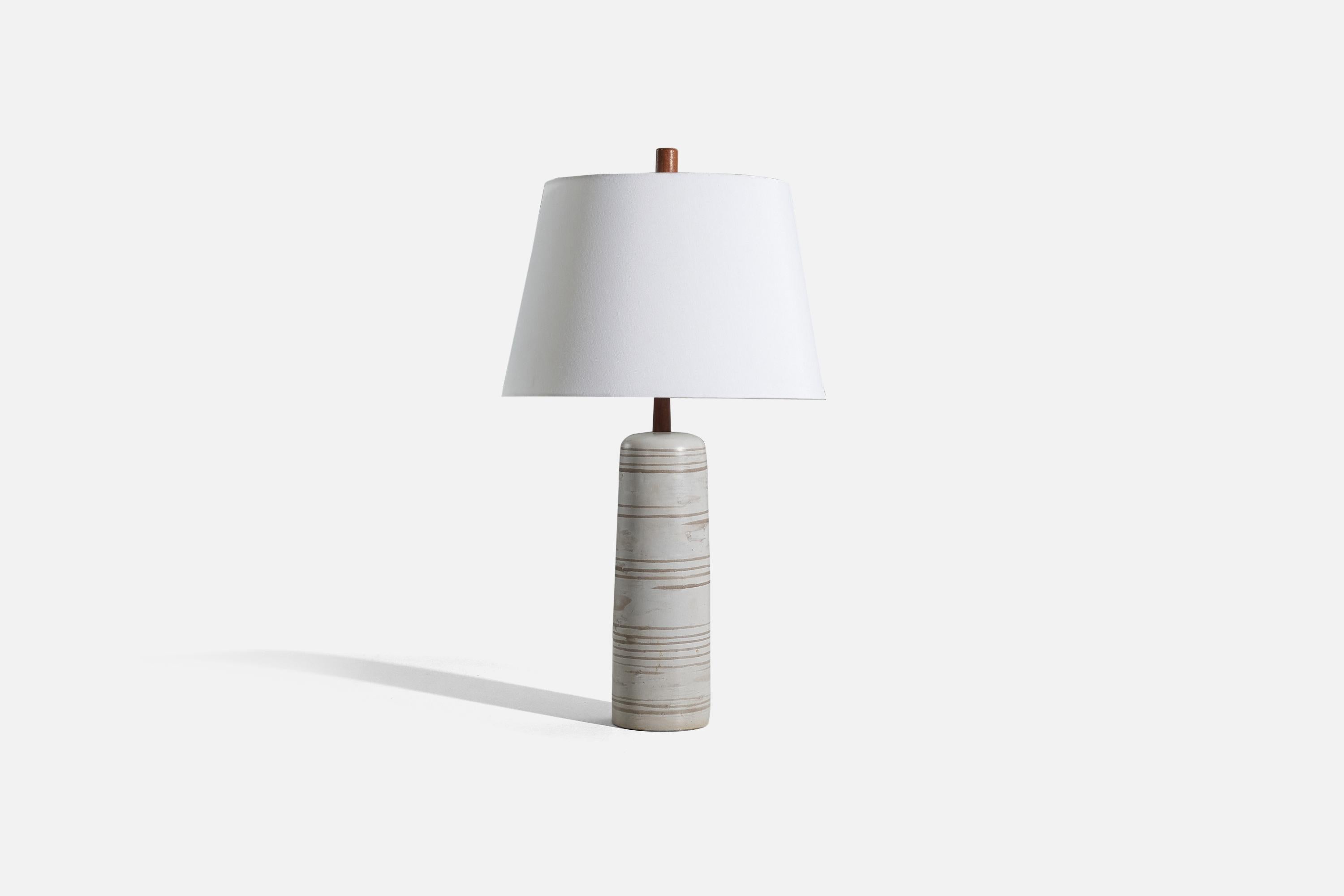 A grey ceramic and walnut table lamp, designed by Jane & Gordon Martz and produced by Marshall Studios, Indianapolis, United States, 1960s.

Sold without lampshade. 
Dimensions of Lamp (inches) : 20 x 5 x 5 (H x W x D)
Dimensions of Shade