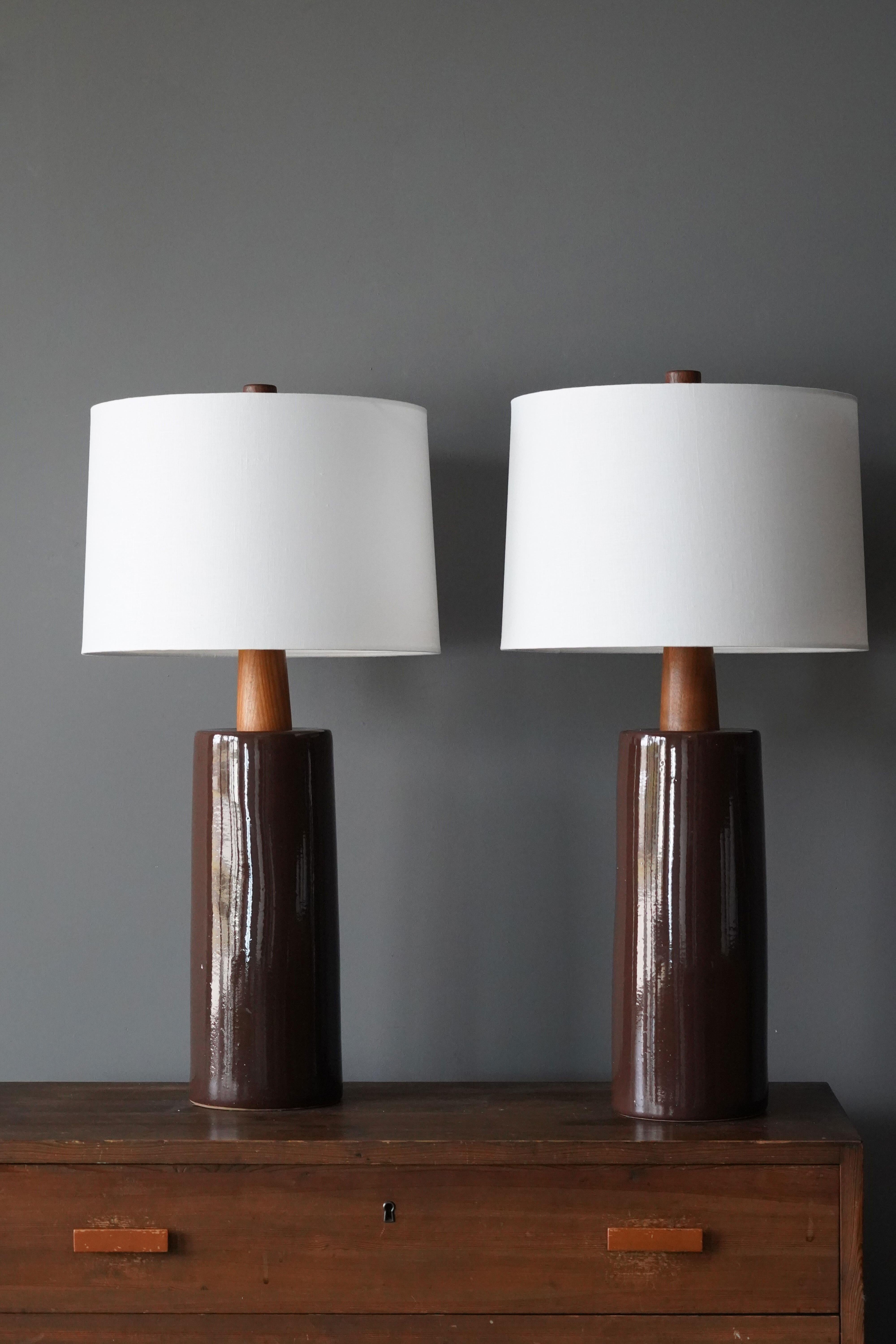 A table lamp designed by husband and wife duo Jane & Gordon Martz. Produced by Marshall Studios, Indianapolis. 

Base is slip-cast and then dipped into glaze. Design also incorporates exquisite walnut necks and finials. Base is signed. 

Sold