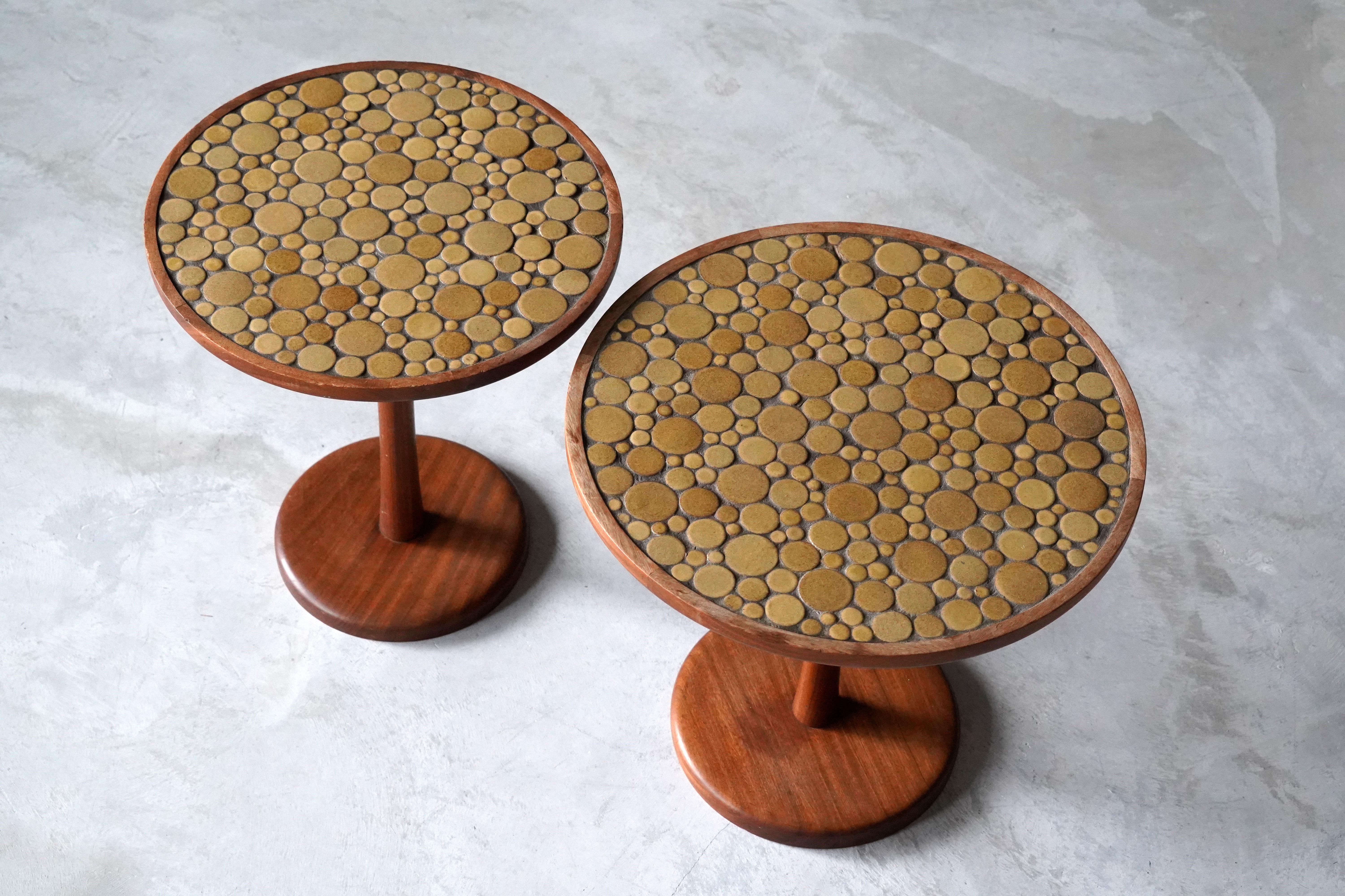 A pair of side tables, designed by husband and wife duo Jane & Gordon Martz. Produced by Marshall Studios, Indianapolis. 

Small ceramic tiles are placed on the top of the wood tables.

Jane & Gordon Martz works are represented in the permanent