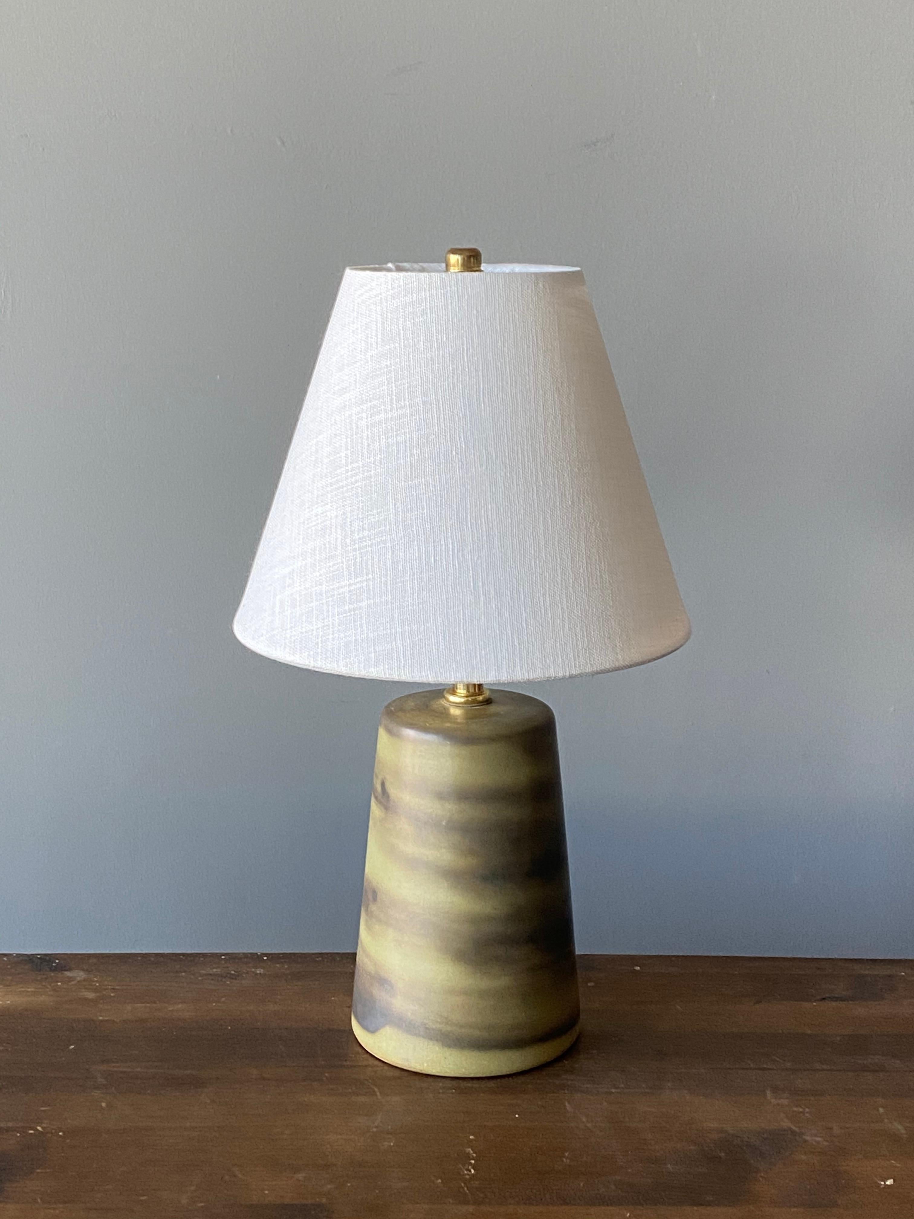 A table lamp designed by husband and wife duo Jane & Gordon Martz. Produced by Marshall Studios, Indianapolis. 

The base is slip-cast and then dipped into glaze and hand painted. Base is signed.

Lampshade on bulb-clip is not included in purchase.