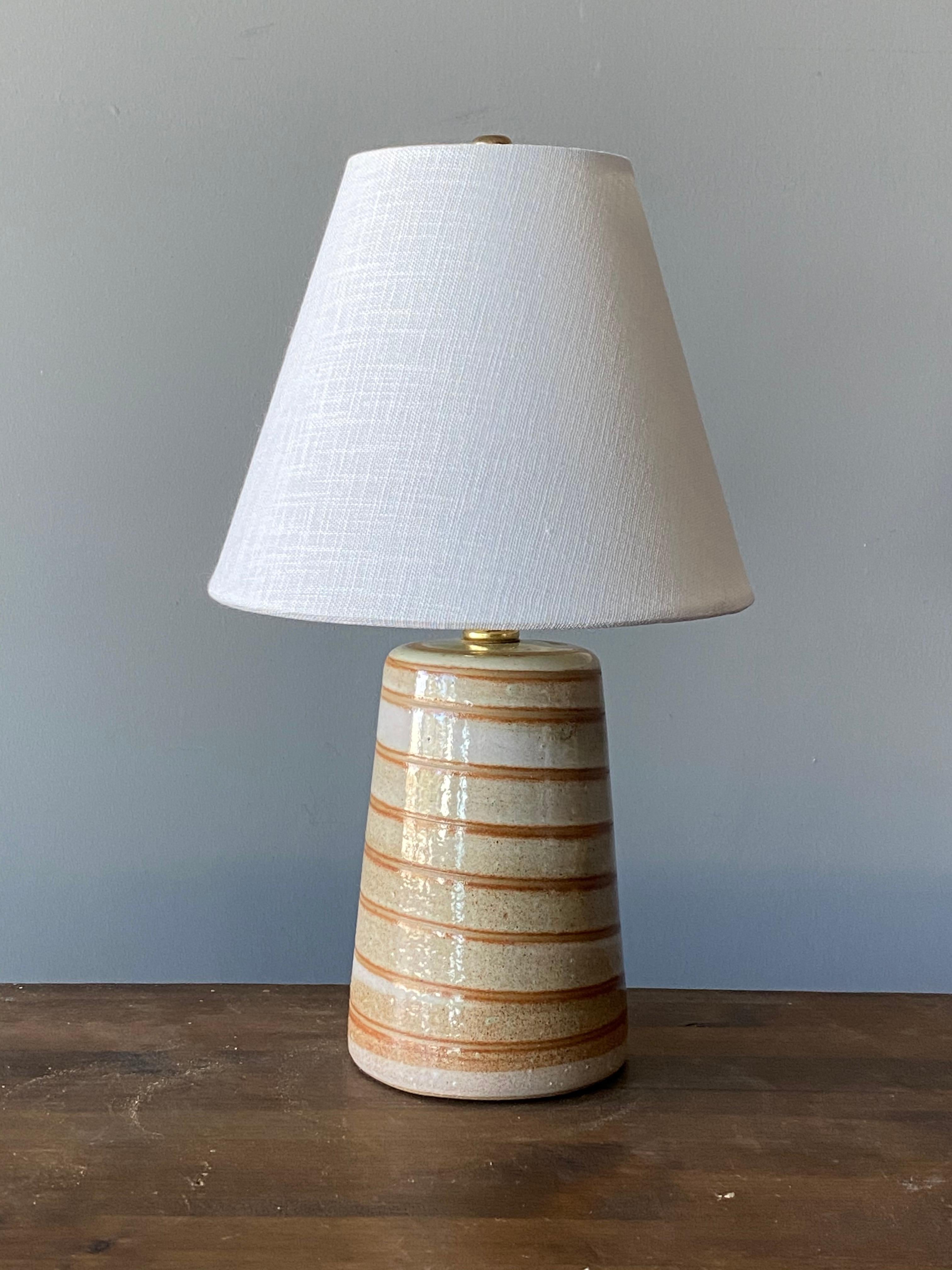 A table lamp designed by husband and wife duo Jane & Gordon Martz. Produced by Marshall Studios, Indianapolis.

The base is slip-cast and then dipped into glaze and hand painted. Base is signed.

Lampshade on bulb-clip is not included in purchase.