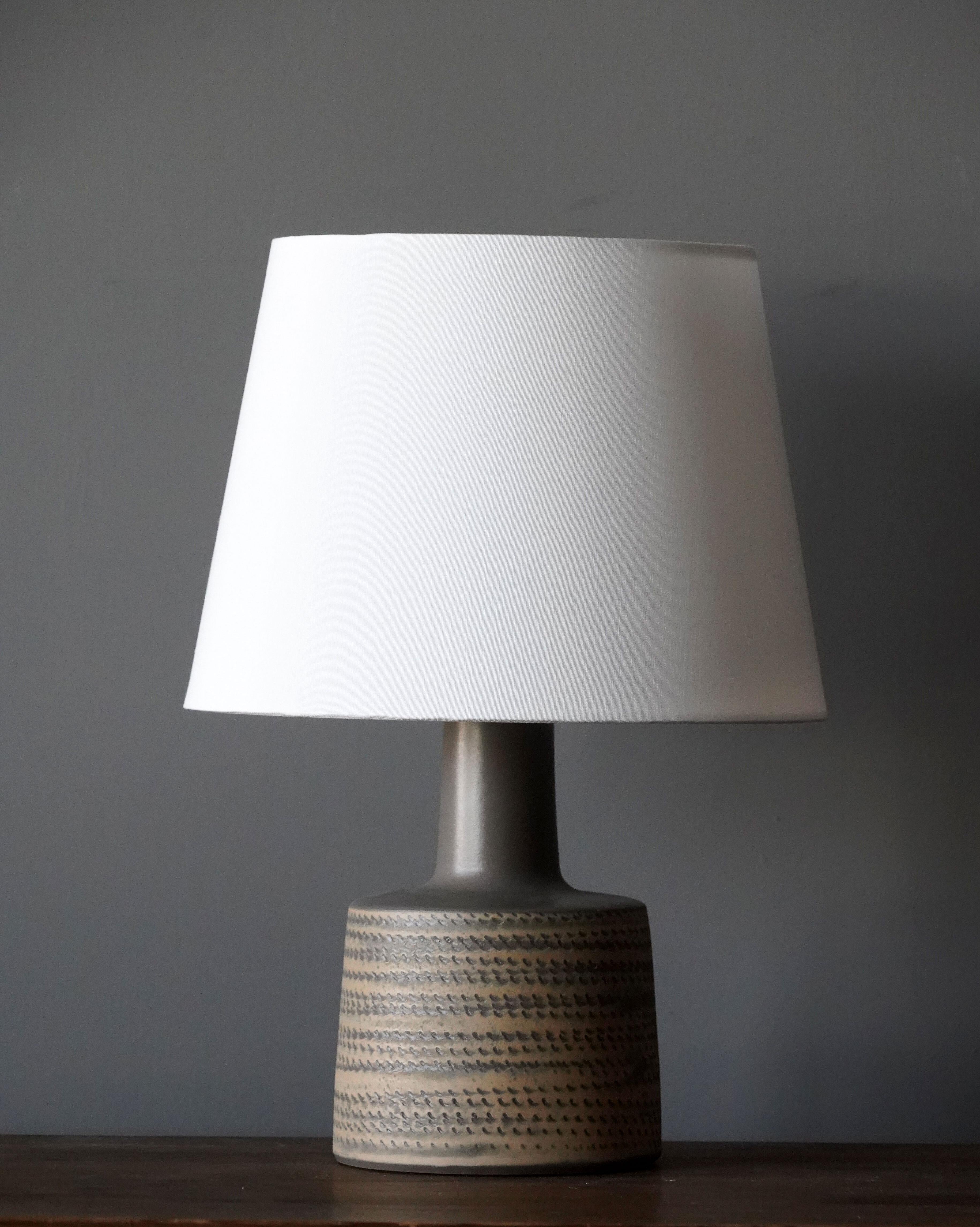 A table lamp designed by husband and wife duo Jane & Gordon Martz. Produced by Marshall Studios, Indianapolis. 

The base is slip-cast and then dipped into glaze and hand painted. Base is signed.

Sold without lampshade. Stated measurements are