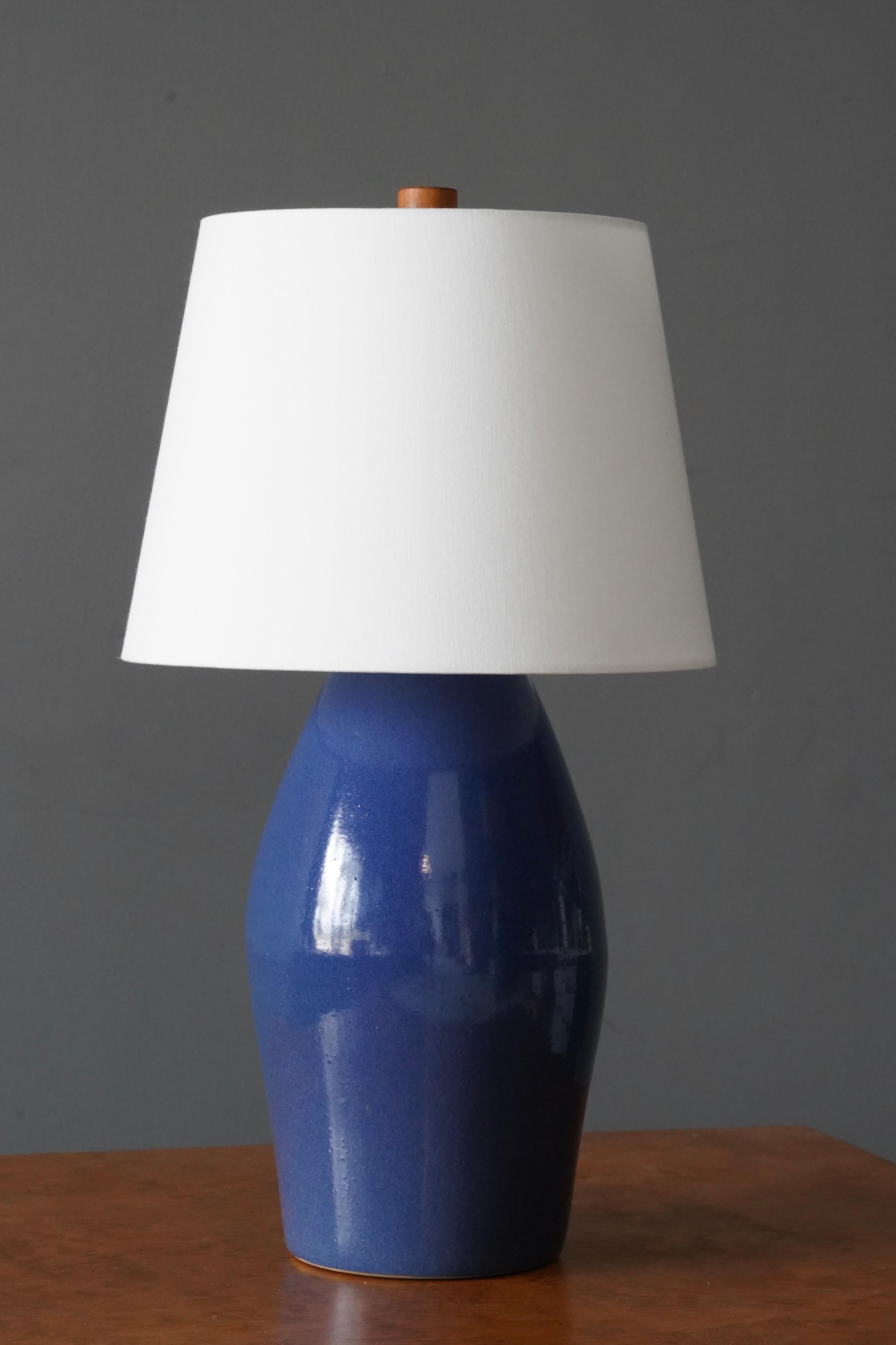 A table lamp designed by husband and wife duo Jane & Gordon Martz. Produced by Marshall Studios, Indianapolis. 

The base is slip-cast and then dipped into glaze. Base is signed.

Sold without lampshade. Stated dimensions exclude lampshade. As