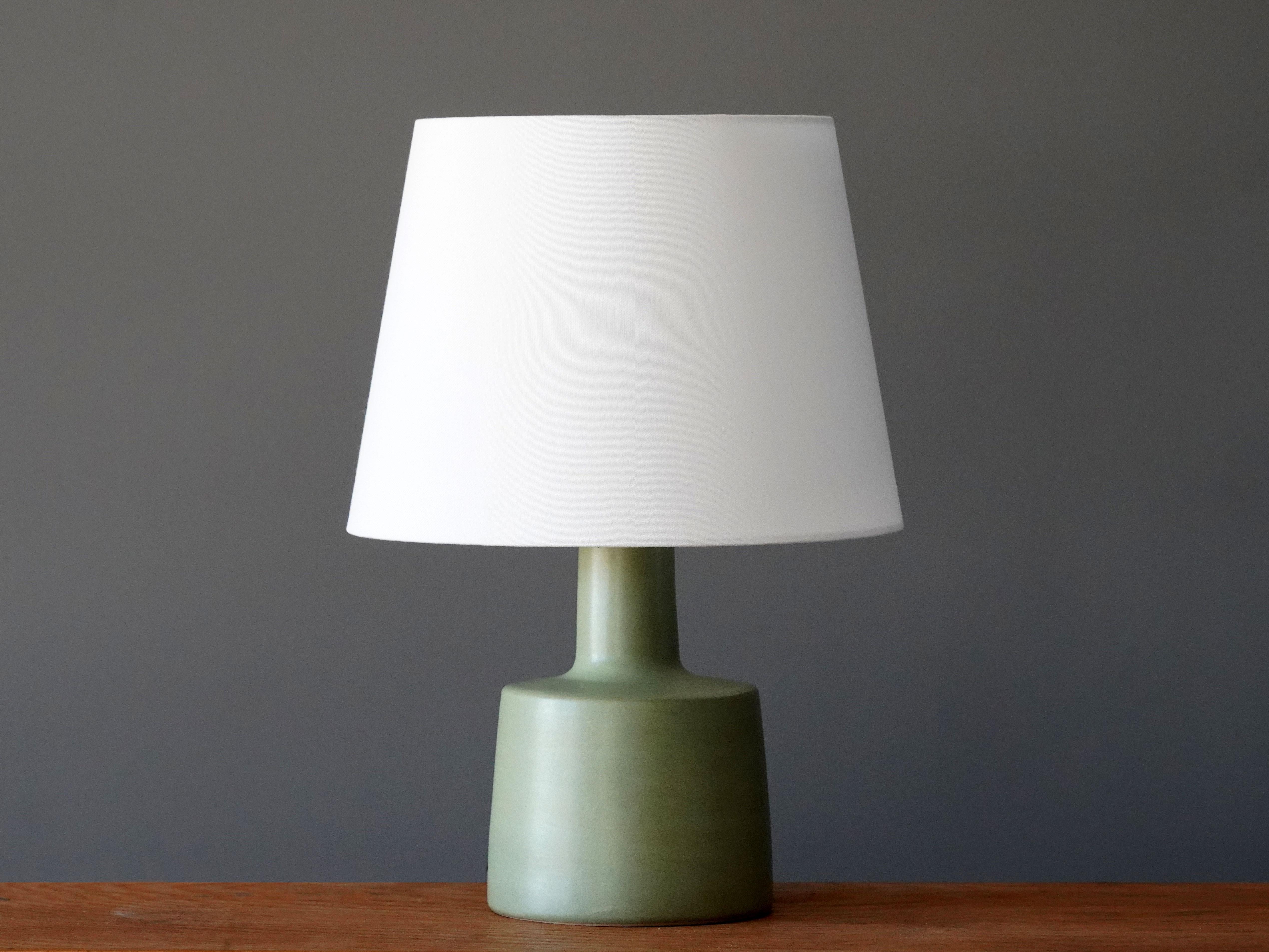 A table lamp designed by husband and wife duo Jane & Gordon Martz. Produced by Marshall Studios, Indianapolis. 

The base is slip-cast and then dipped into glaze and hand painted. Base is signed. Sold without lampshade.

Jane & Gordon Martz works