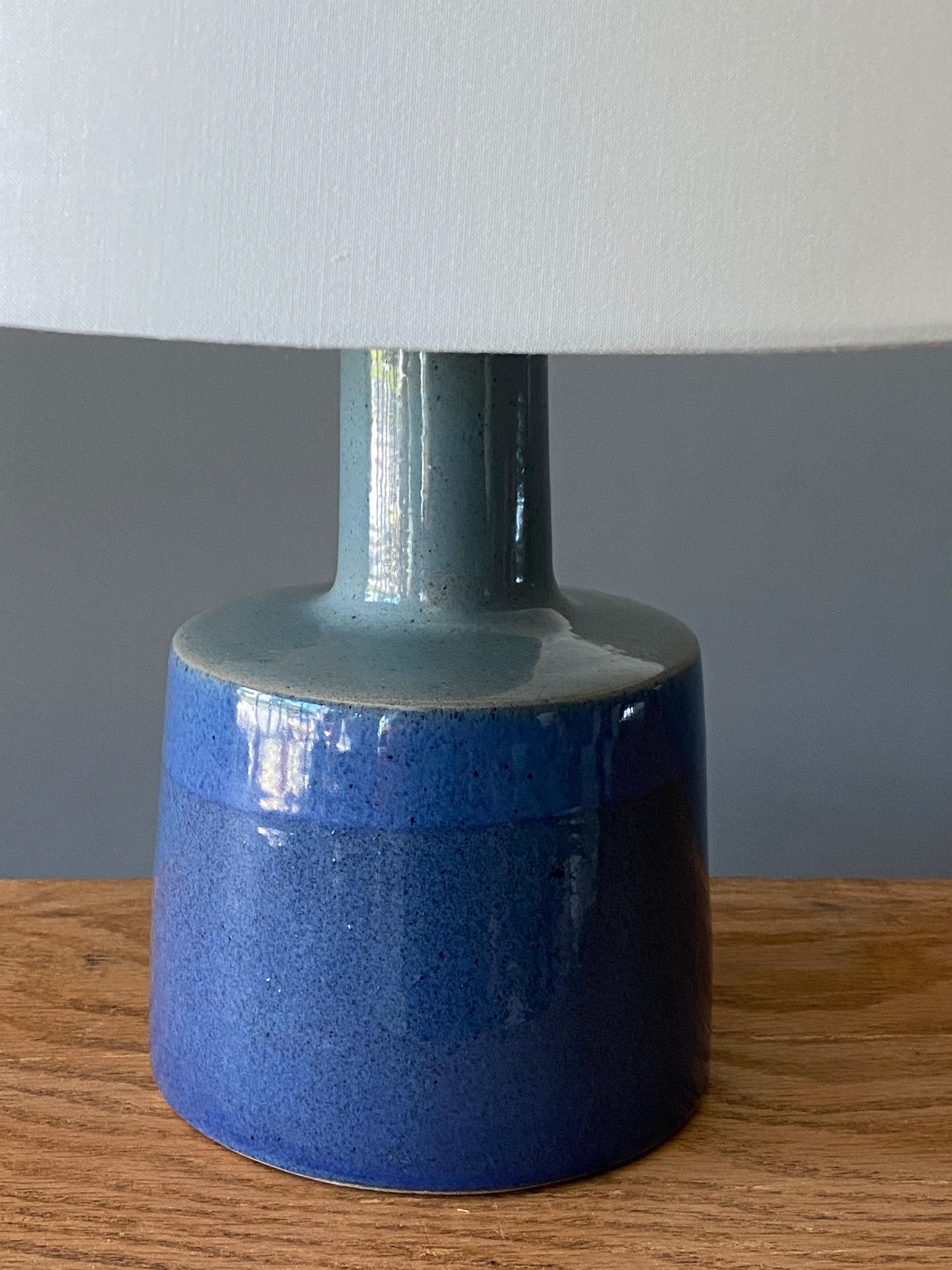 A table lamp designed by husband and wife duo Jane & Gordon Martz. Produced by Marshall Studios, Indianapolis. 

The base is slip-cast and then dipped into glaze and hand-painted. Base is signed. Sold without lampshade.

Jane & Gordon Martz works