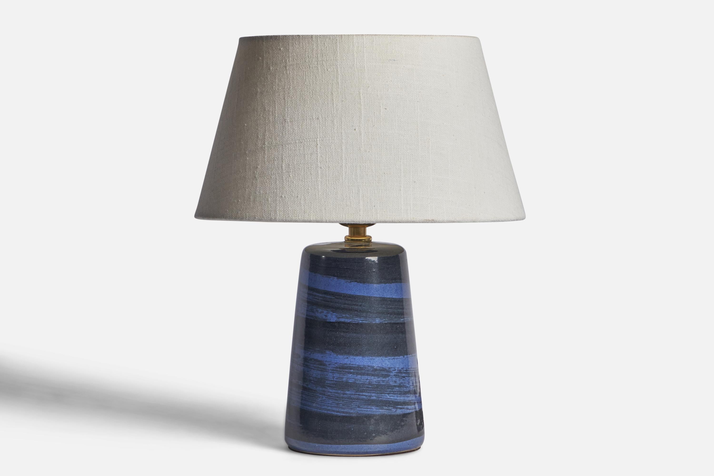 A blue-glazed ceramic and table lamp designed by Jane & Gordon Martz and produced by Marshall Studios, USA, 1960s.

Dimensions of Lamp (inches): 9.15” H x 4.3” Diameter
Dimensions of Shade (inches): 7” Top Diameter x 10” Bottom Diameter x