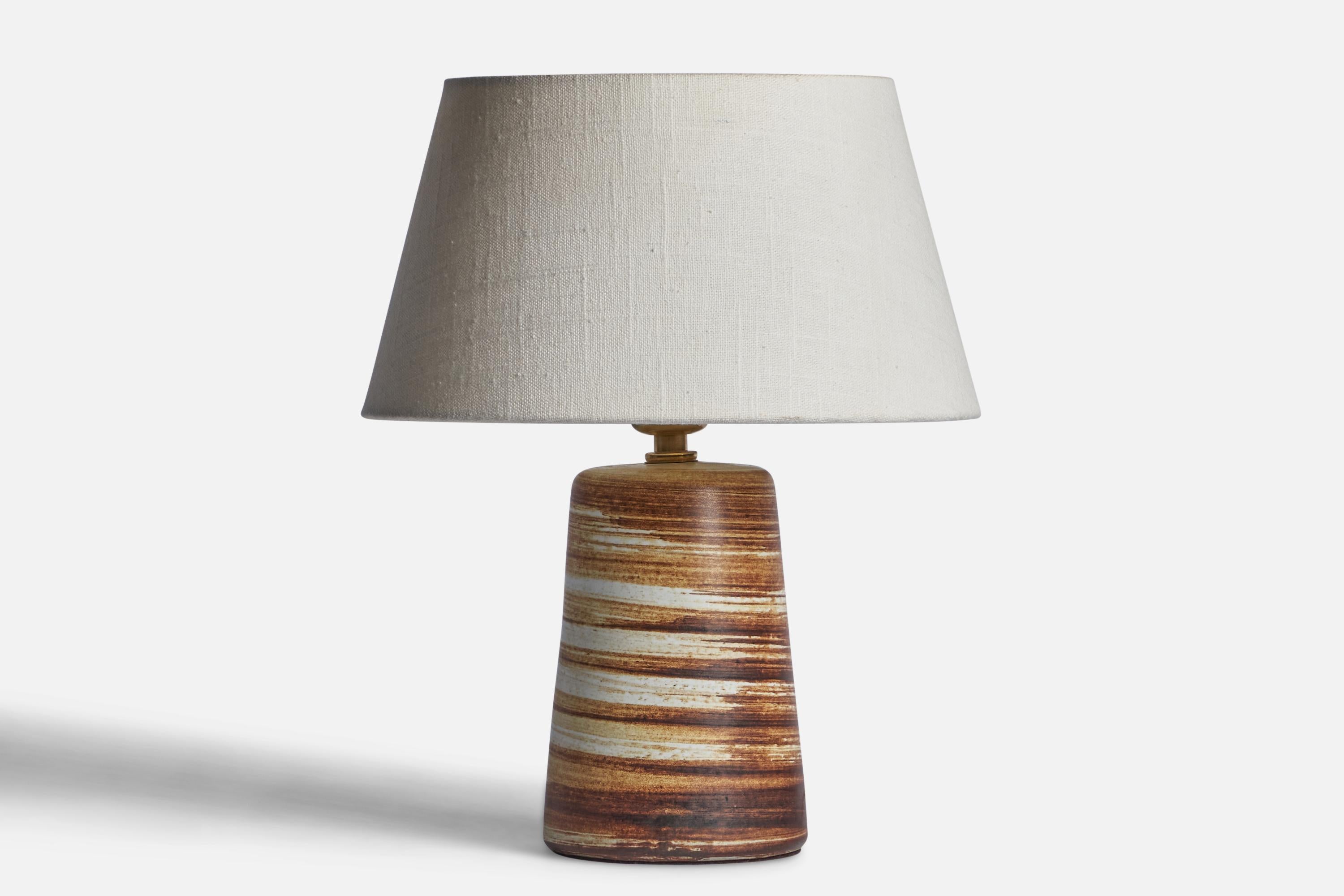 A beige and brown-glazed ceramic table lamp designed by Jane & Gordon Martz and produced by Marshall Studios, USA, 1960s.
Dimensions of Lamp (inches): 9.2” H x 4.3” Diameter
Dimensions of Shade (inches): 7” Top Diameter x 10” Bottom Diameter x 5.5”