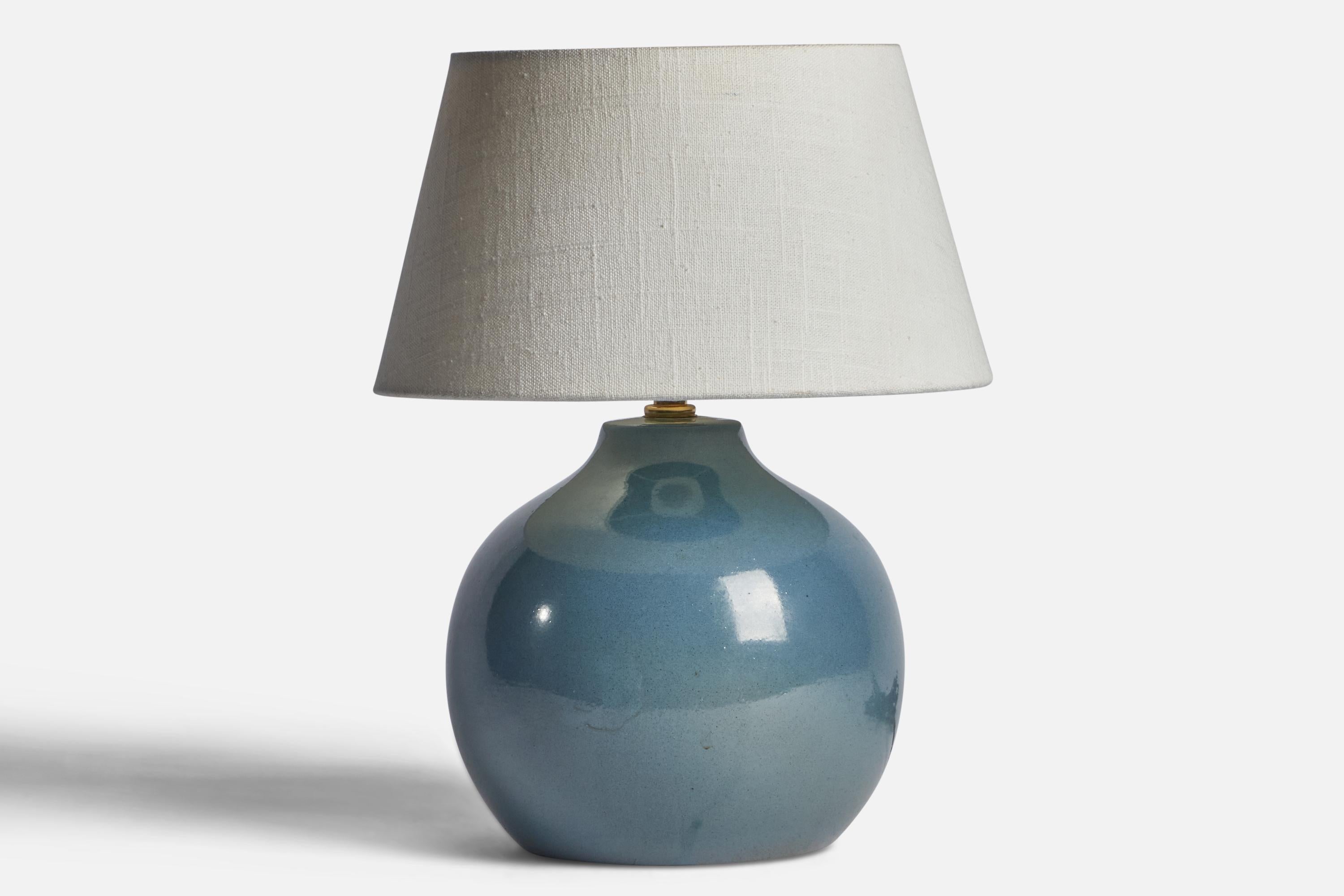 A blue-glazed ceramic table lamp designed by Jane & Gordon Martz and produced by Marshall Studios, USA, 1960s.

Dimensions of Lamp (inches): 9.85” H x 7.3” Diameter
Dimensions of Shade (inches): 7” Top Diameter x 10” Bottom Diameter x 5.5” H