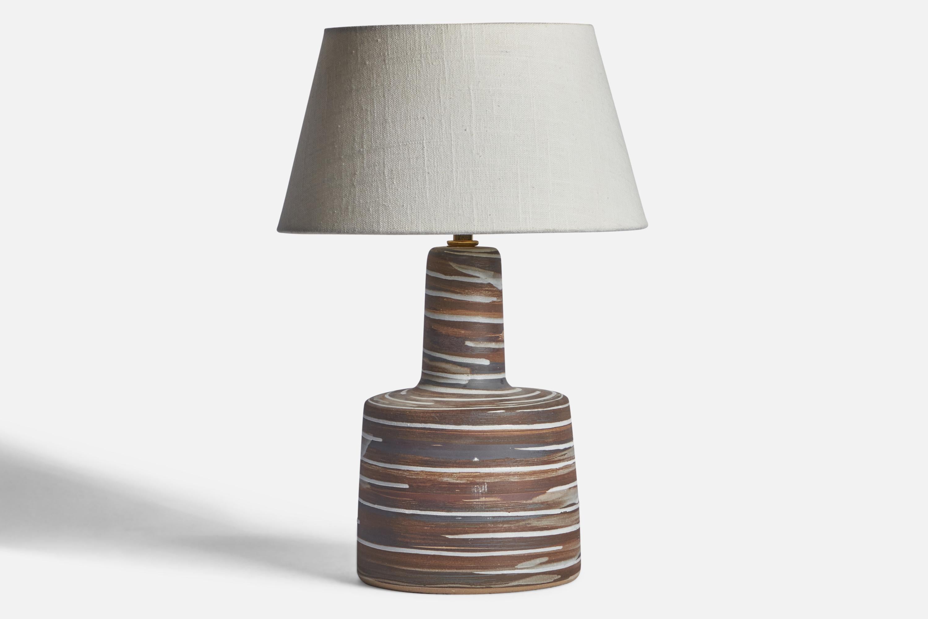 An grey and brown-glazed ceramic table lamp designed by Jane & Gordon Martz and produced by Marshall Studios, USA, 1960s.

Dimensions of Lamp (inches): 11.9” H x 6.15” Diameter
Dimensions of Shade (inches): 7” Top Diameter x 10” Bottom Diameter x
