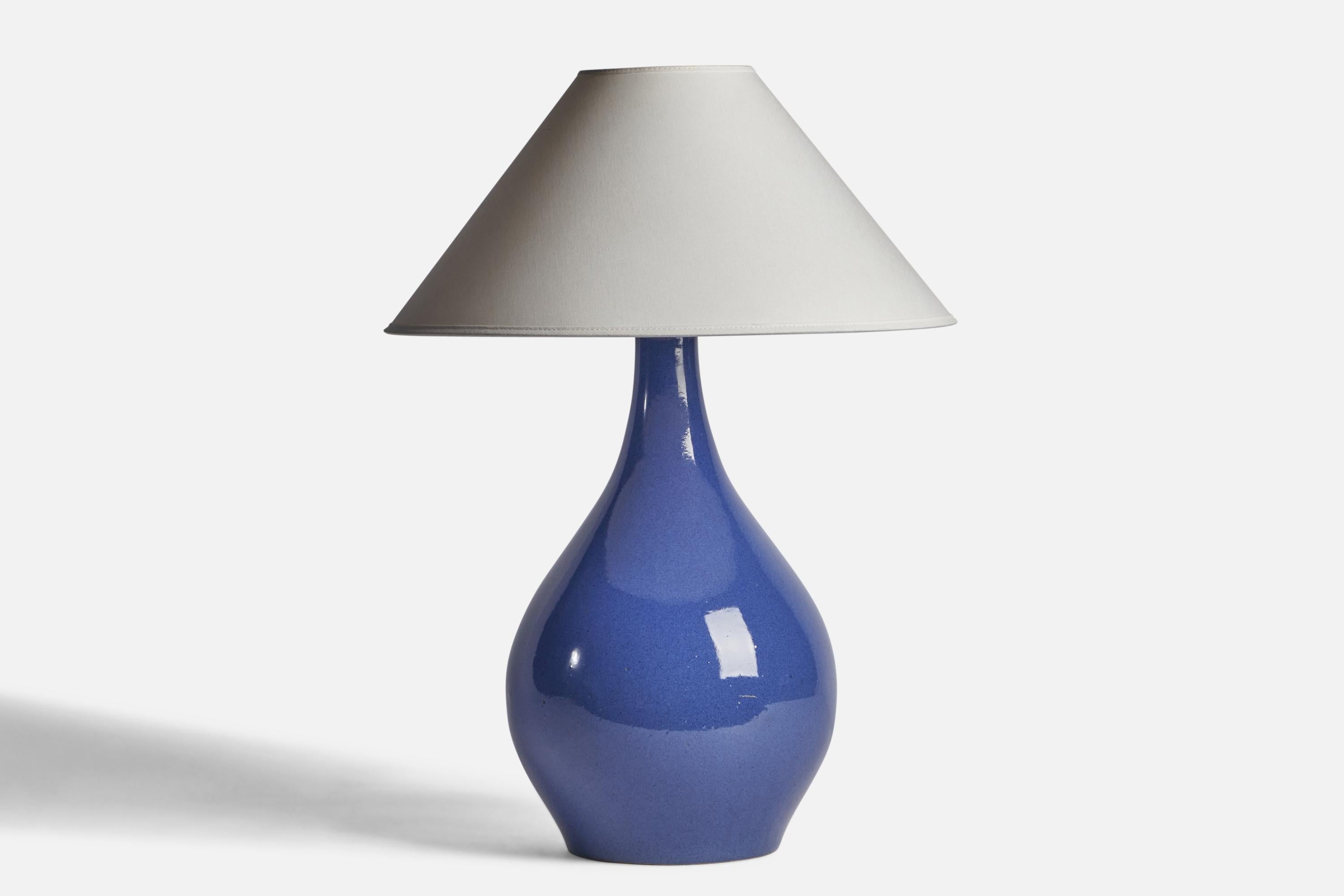 A blue-glazed ceramic table lamp designed by Jane & Gordon Martz and produced by Marshall Studios, USA, 1960s.

Dimensions of Lamp (inches): 17.75” H x 9.5” Diameter
Dimensions of Shade (inches): 4.5” Top Diameter x 16” Bottom Diameter x 7.25”