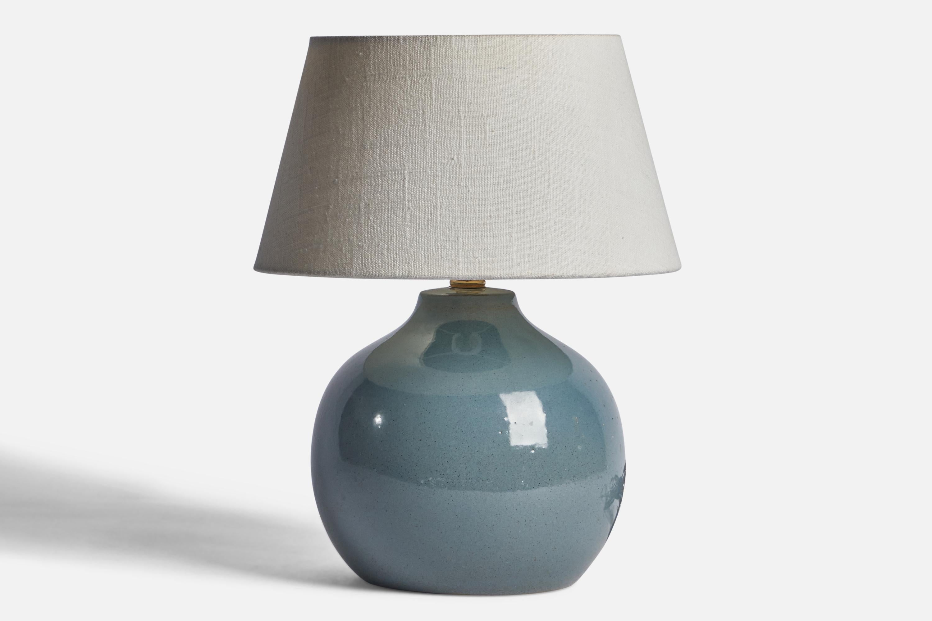 A blue-glazed ceramic table lamp designed by Jane & Gordon Martz and produced by Marshall Studios, USA, 1960s.

Dimensions of Lamp (inches): 9.75” H x 4.15” Diameter
Dimensions of Shade (inches): 7” Top Diameter x 10” Bottom Diameter x 5.5” H