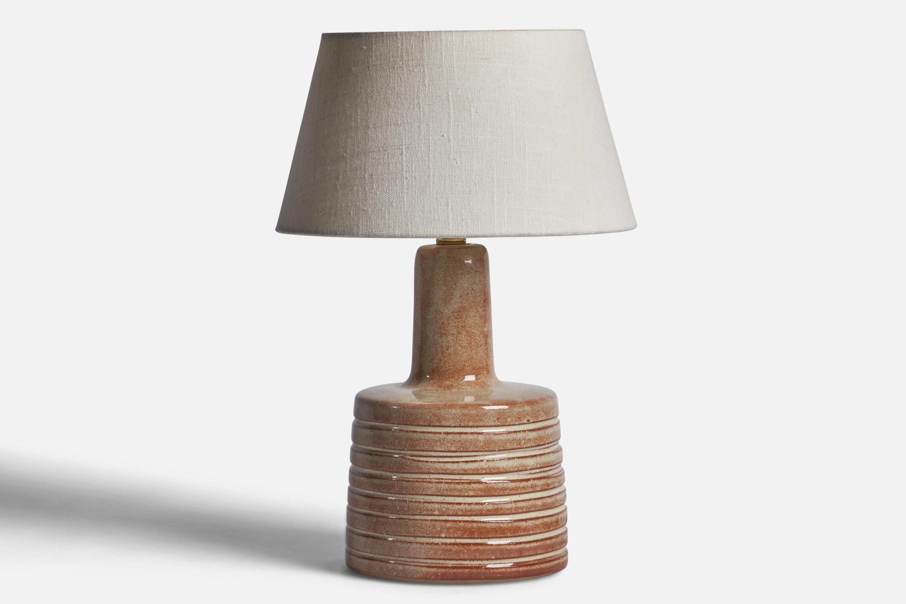 A beige and red-glazed ceramic table lamp designed by Jane & Gordon Martz and produced by Marshall Studios, USA, 1960s.

Dimensions of Lamp (inches): 12” H x 6.05” Diameter
Dimensions of Shade (inches): 7” Top Diameter x 10” Bottom Diameter x 5.5” H