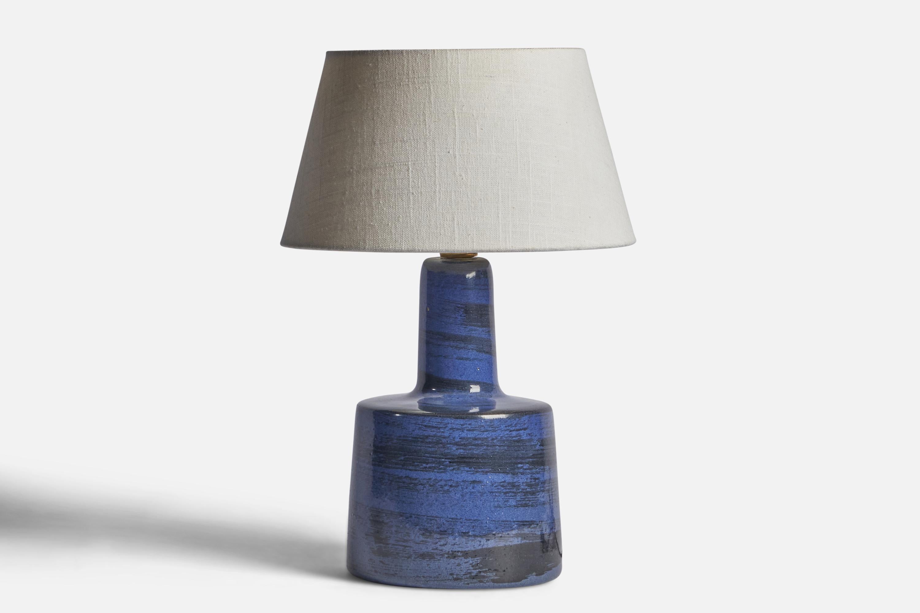 A blue-glazed ceramic table lamp designed by Jane & Gordon Martz and produced by Marshall Studios, USA, 1960s.

Dimensions of Lamp (inches): 12” H x 6.25” Diameter
Dimensions of Shade (inches): 7” Top Diameter x 10” Bottom Diameter x 5.5” H