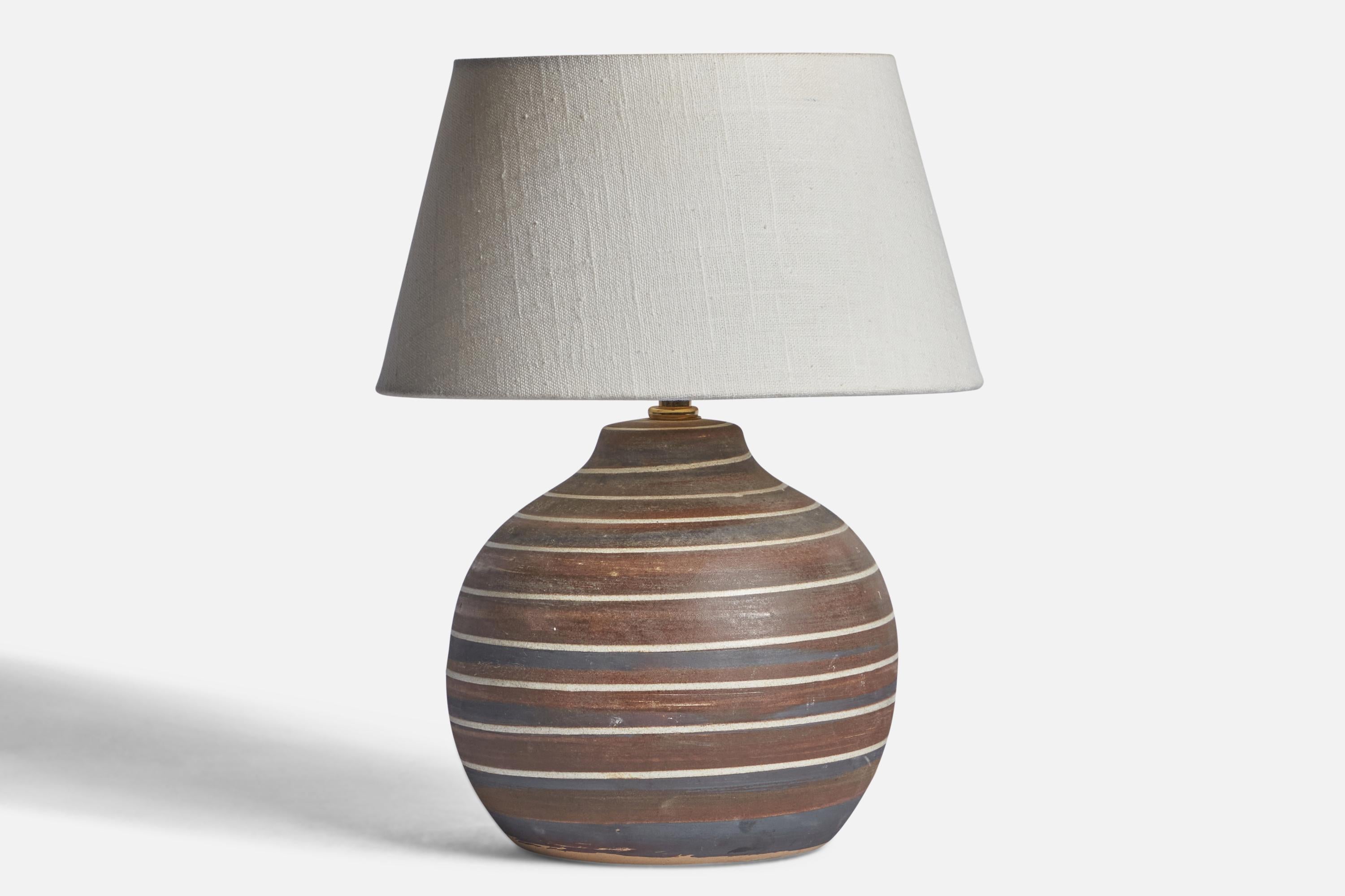 A grey and brown-glazed ceramic table lamp designed by Jane & Gordon Martz and produced by Marshall Studios, USA, 1960s.

Dimensions of Lamp (inches): 10” H x 7.3” Diameter
Dimensions of Shade (inches): 7” Top Diameter x 10” Bottom Diameter x 5.5” H