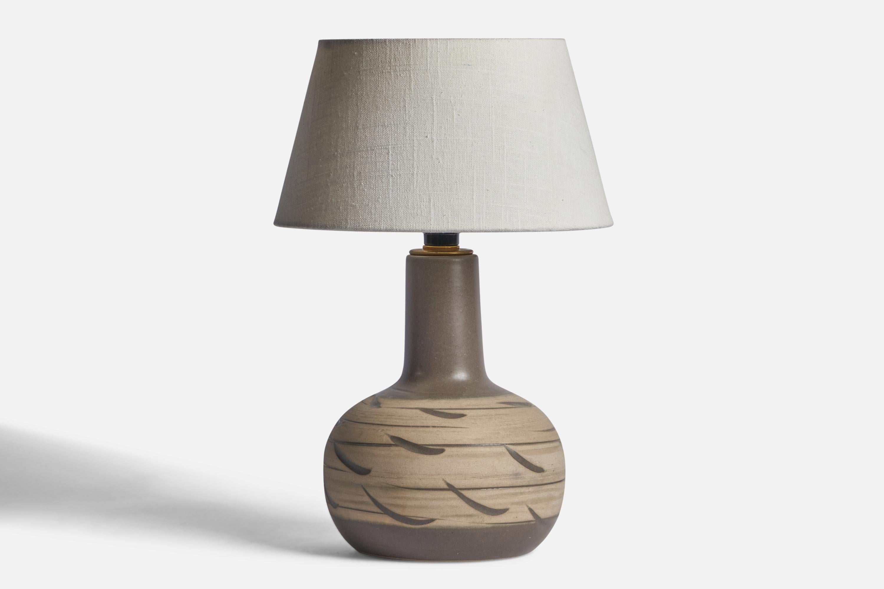 A grey-glazed ceramic table lamp designed by Jane & Gordon Martz and produced by Marshall Studios, USA, 1960s.
Dimensions of Lamp (inches): 12.25” H x 7.2” Diameter
Dimensions of Shade (inches): 7” Top Diameter x 10” Bottom Diameter x 5.5” H