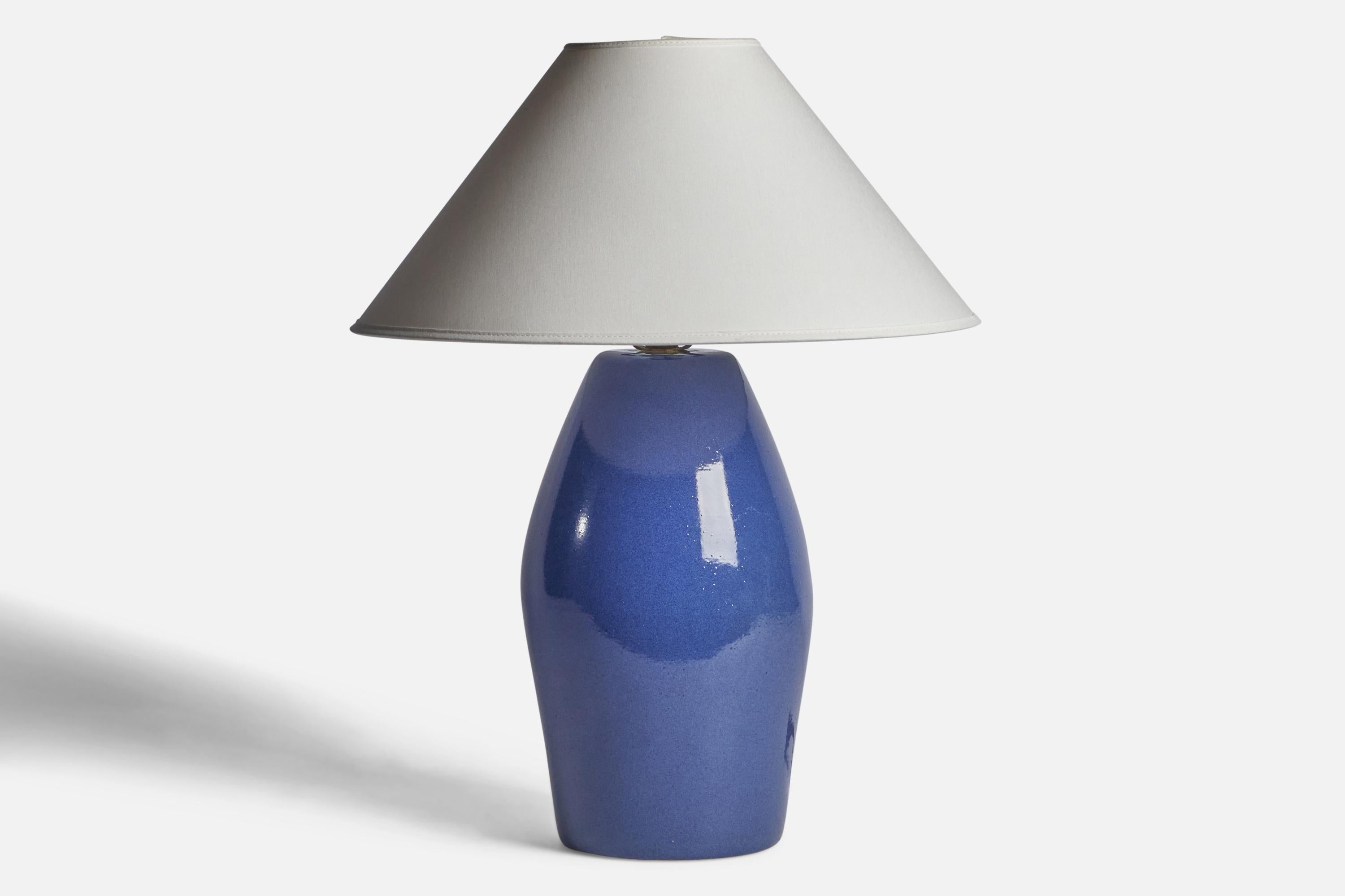 A blue-glazed ceramic table lamp designed by Jane & Gordon Martz and produced by Marshall Studios, USA, 1960s.

Dimensions of Lamp (inches): 15.5” H x 7.15” Diameter
Dimensions of Shade (inches): 4.5” Top Diameter x 16” Bottom Diameter x 7.15” H