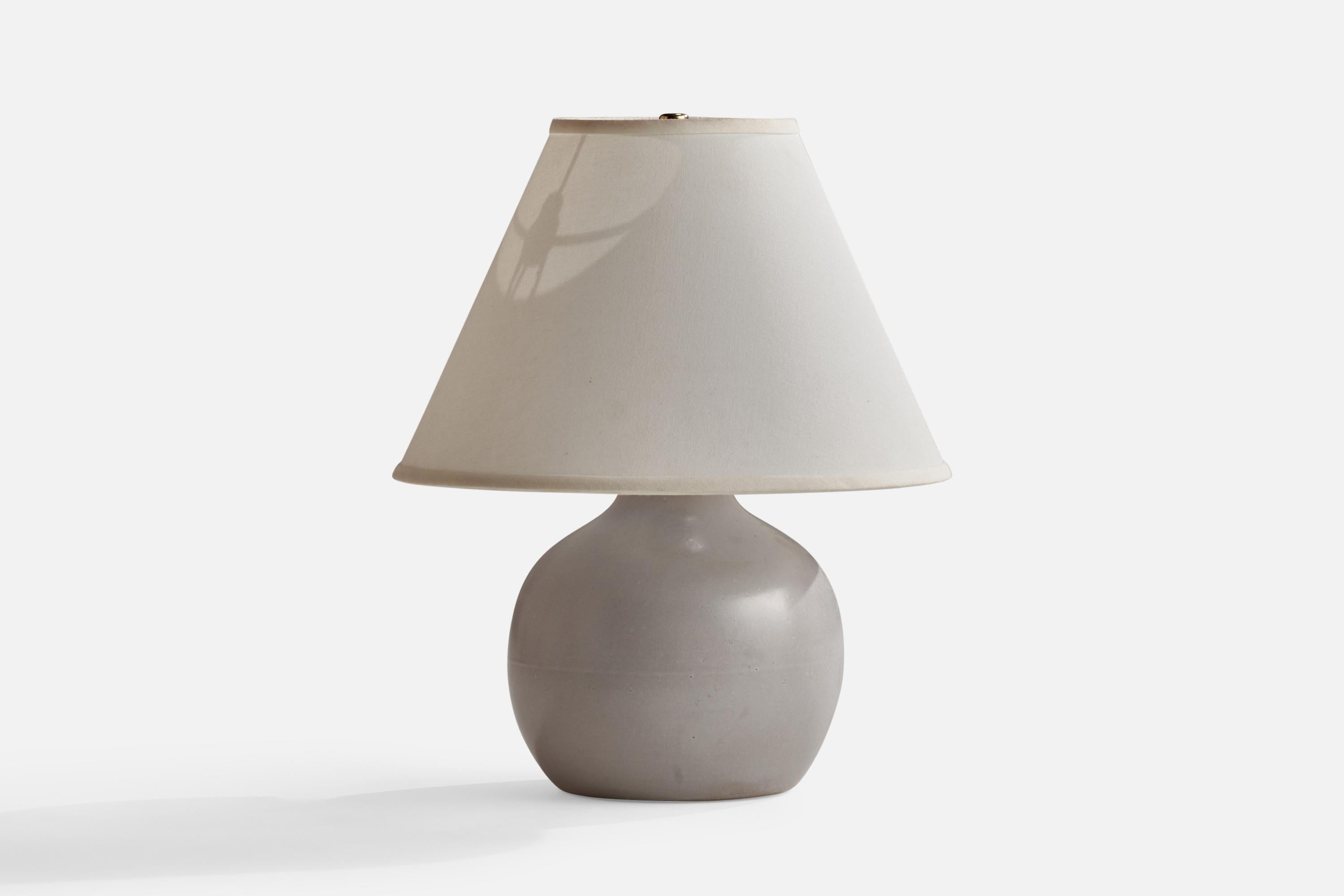 A grey-glazed ceramic table lamp designed by Jane & Gordon Martz and produced by Marshall Studios, USA, 1960s.

Overall Dimensions (inches): 14.5” H x 11.5” W x 7” D
Stated dimensions include shade.
Bulb Specifications: E-26 Bulb
Number of Sockets:
