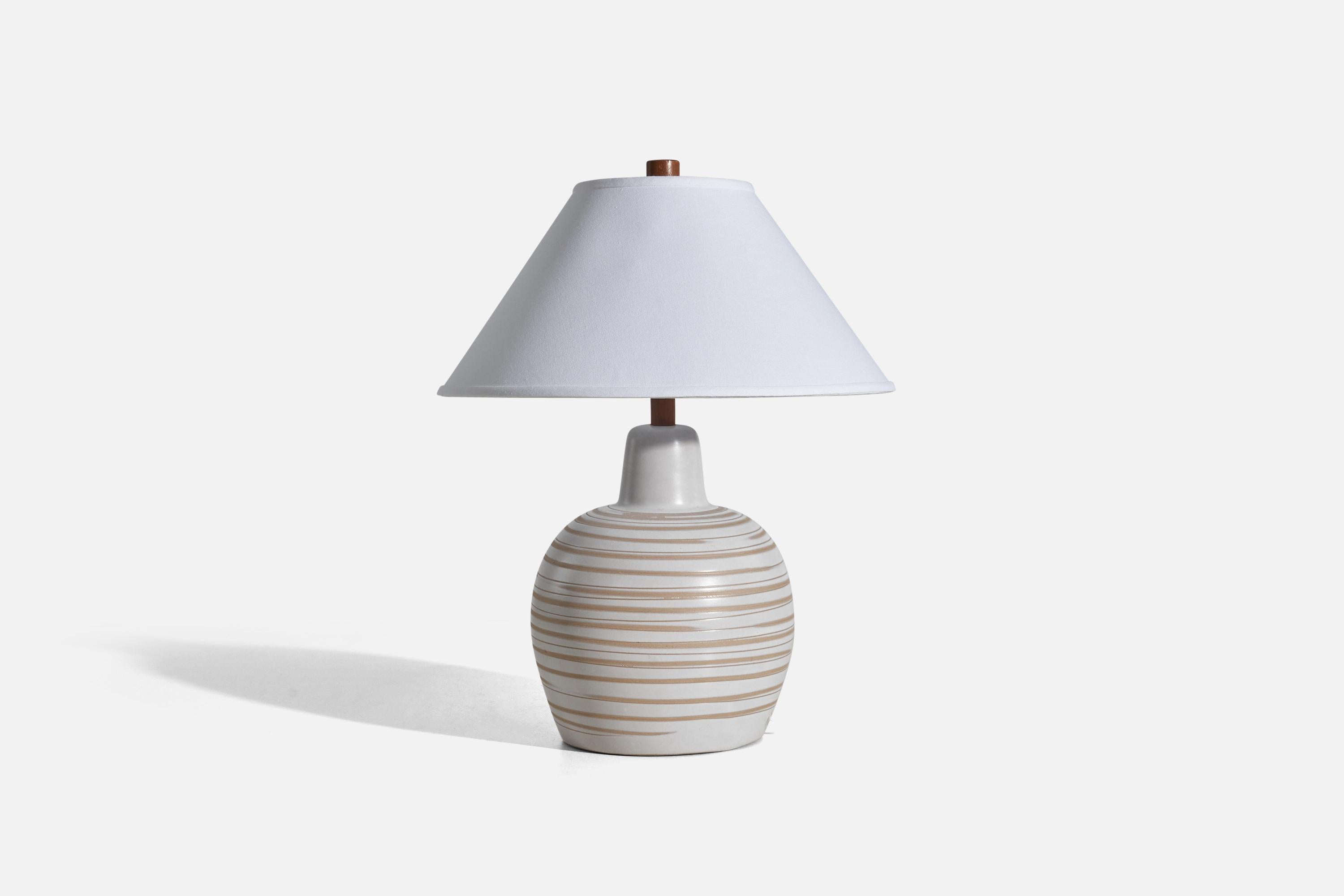 A white and beige ceramic and walnut table lamp designed by Jane & Gordon Martz and produced by Marshall Studios, Indianapolis, 1950s.

Sold without Lampshade
Dimensions of Lamp (inches) : 15.62 x 9.56 x 9.56 (Height x Width x Depth)
Dimensions of