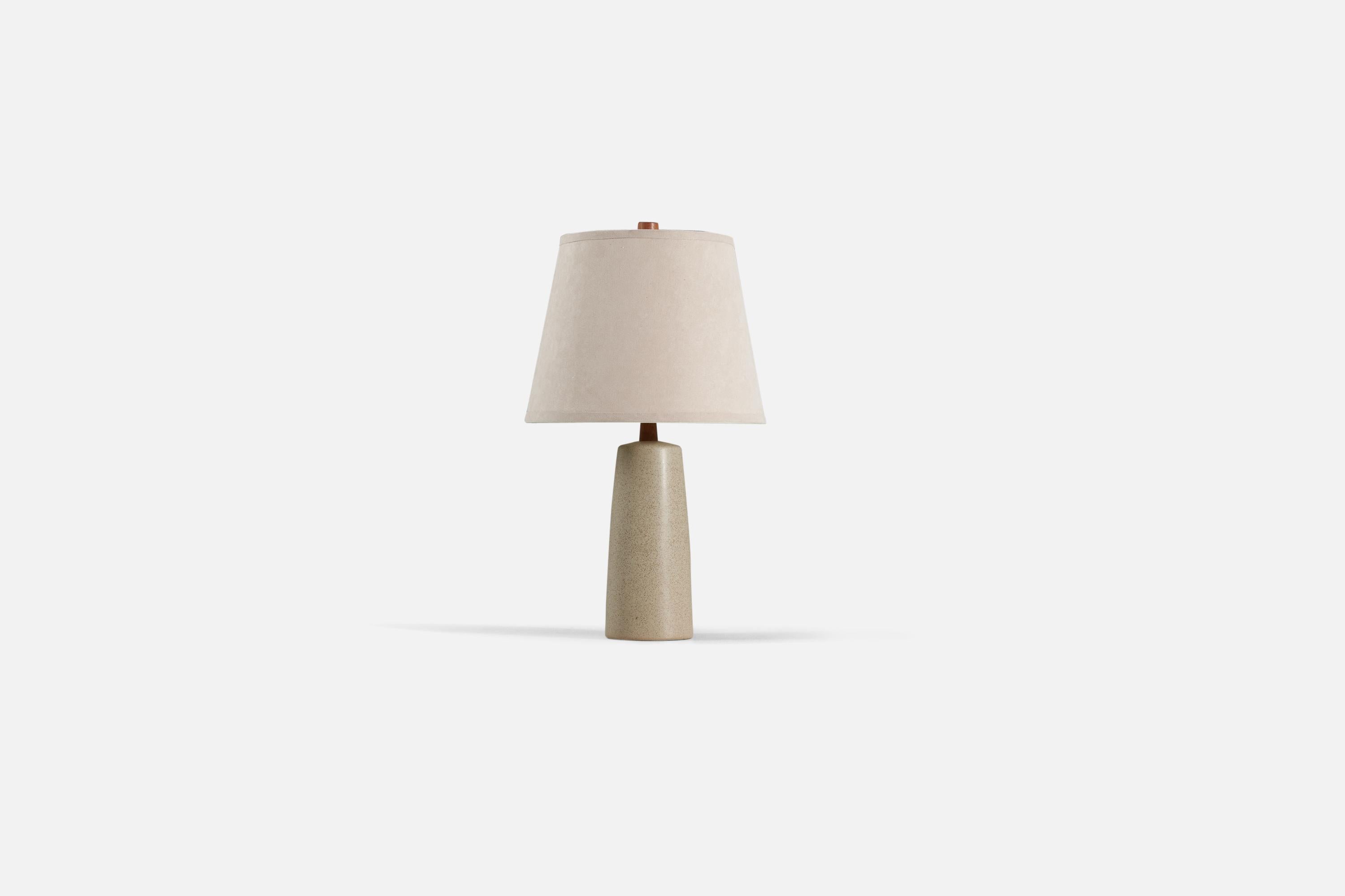 A tan table lamp with brown speckled glaze designed by husband and wife duo Jane & Gordon Martz. Produced by Marshall Studios, Indianapolis. 

The base is slip-cast and then dipped into glaze. The design also incorporates an exquisite walnut neck