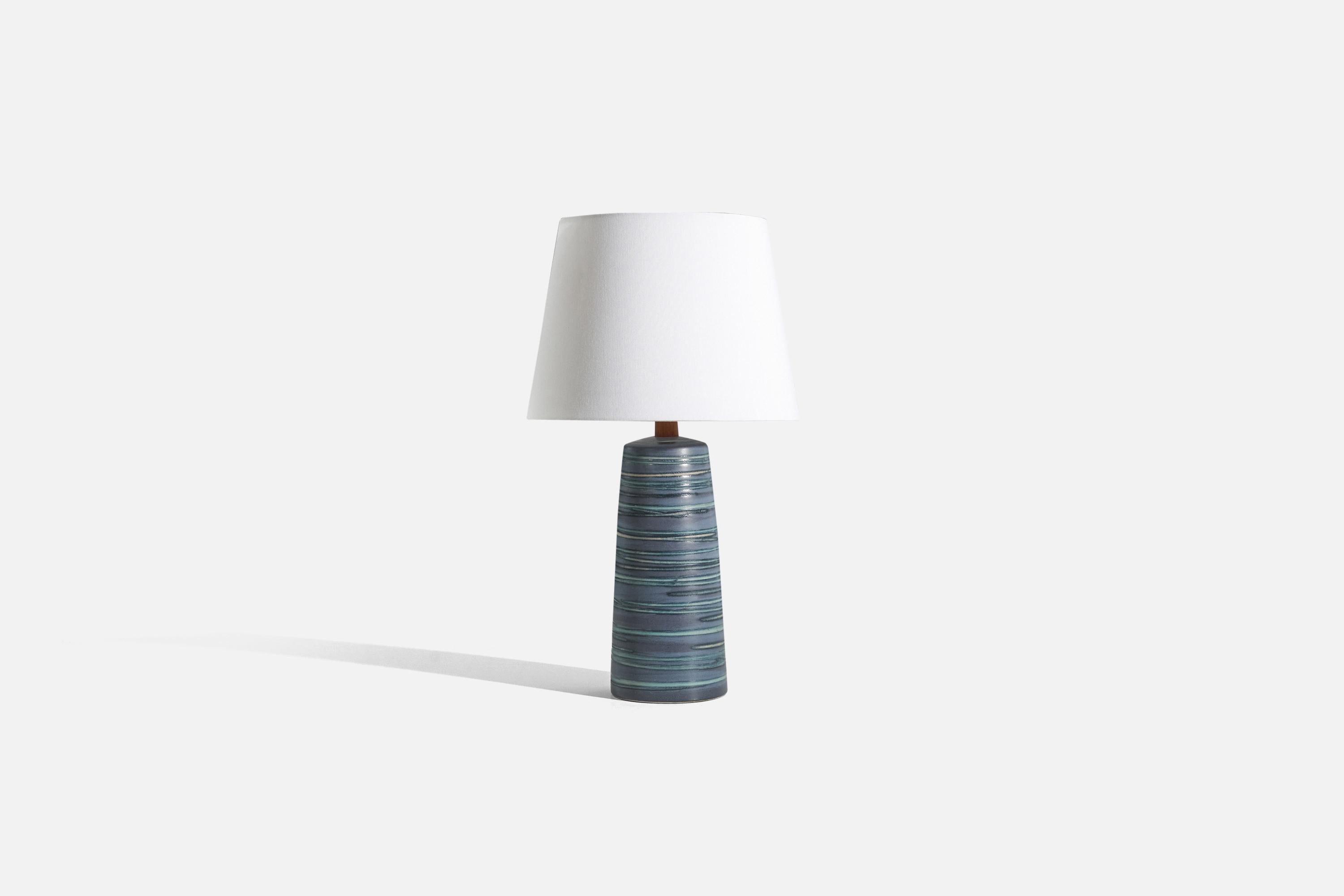 A blue ceramic and walnut table lamp, designed by Jane & Gordon Martz and produced by Marshall Studios, Indianapolis, United States, 1960s.

Sold without lampshade. 
Dimensions of Lamp (inches) : 16.75 x 5.25 x 5.25 (H x W x D)
Dimensions of