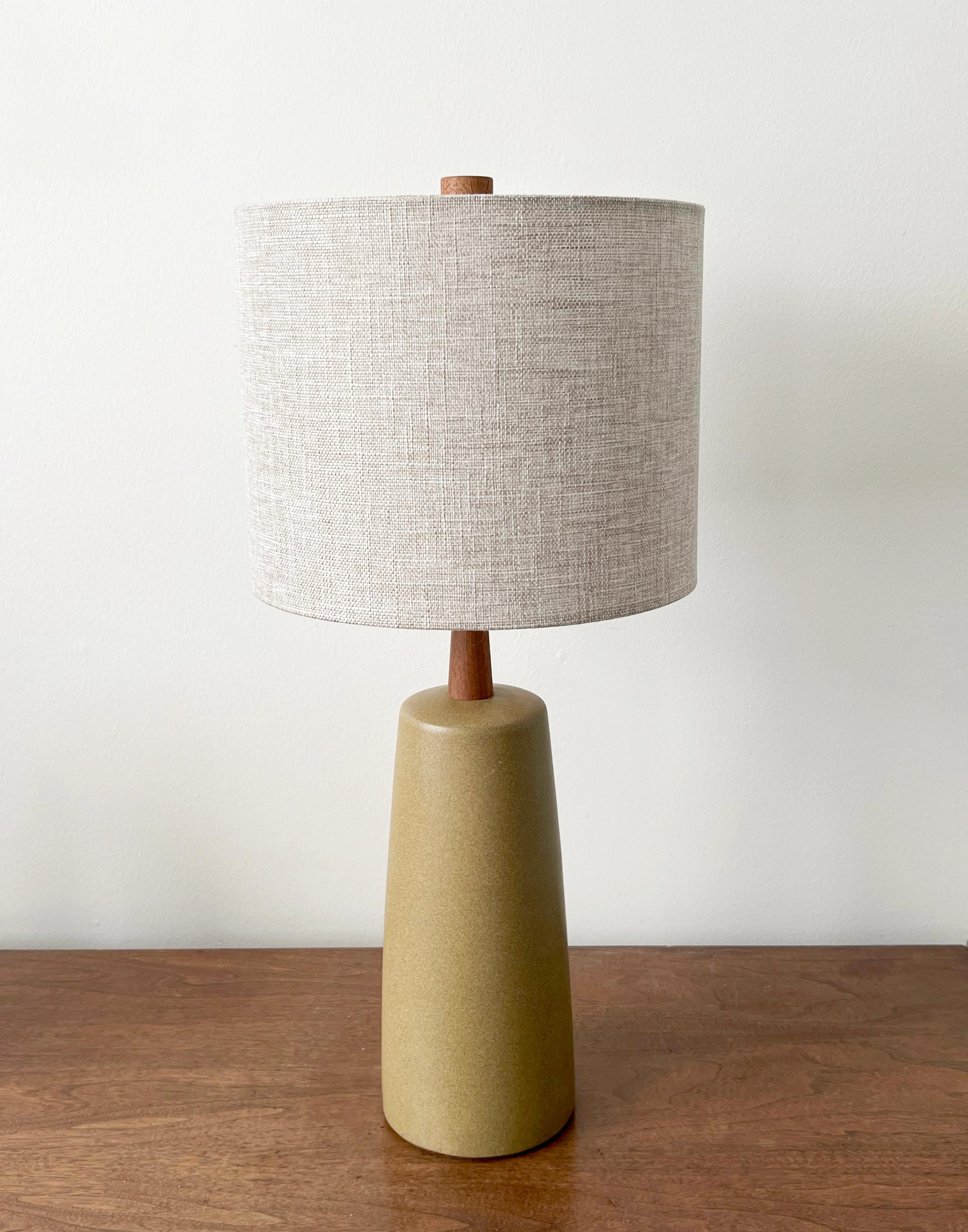 A yellow ochre speckled matte glaze table lamp designed by husband and wife duo Jane & Gordon Martz. Produced by Marshall Studios, Indianapolis.

Sold without lampshade. Dimensions in listing exclude shade.
 