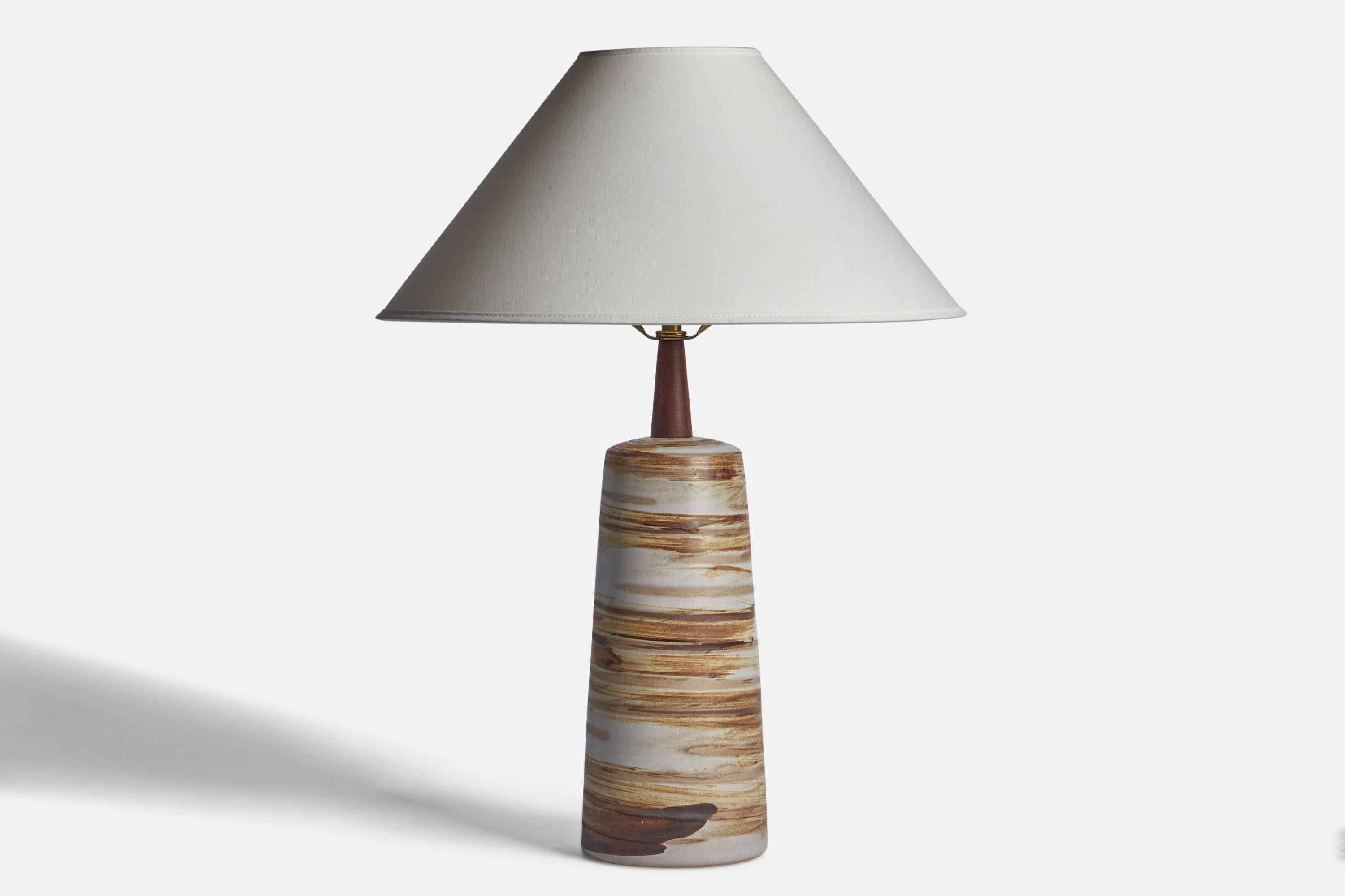 A light grey and brown-glazed ceramic and walnut table lamp designed by Jane & Gordon Martz and produced by Marshall Studios, USA, 1960s.

Dimensions of Lamp (inches): 16.95” H x 5.1” aA light grey and brown-glazed ceramic and walnut table lamp