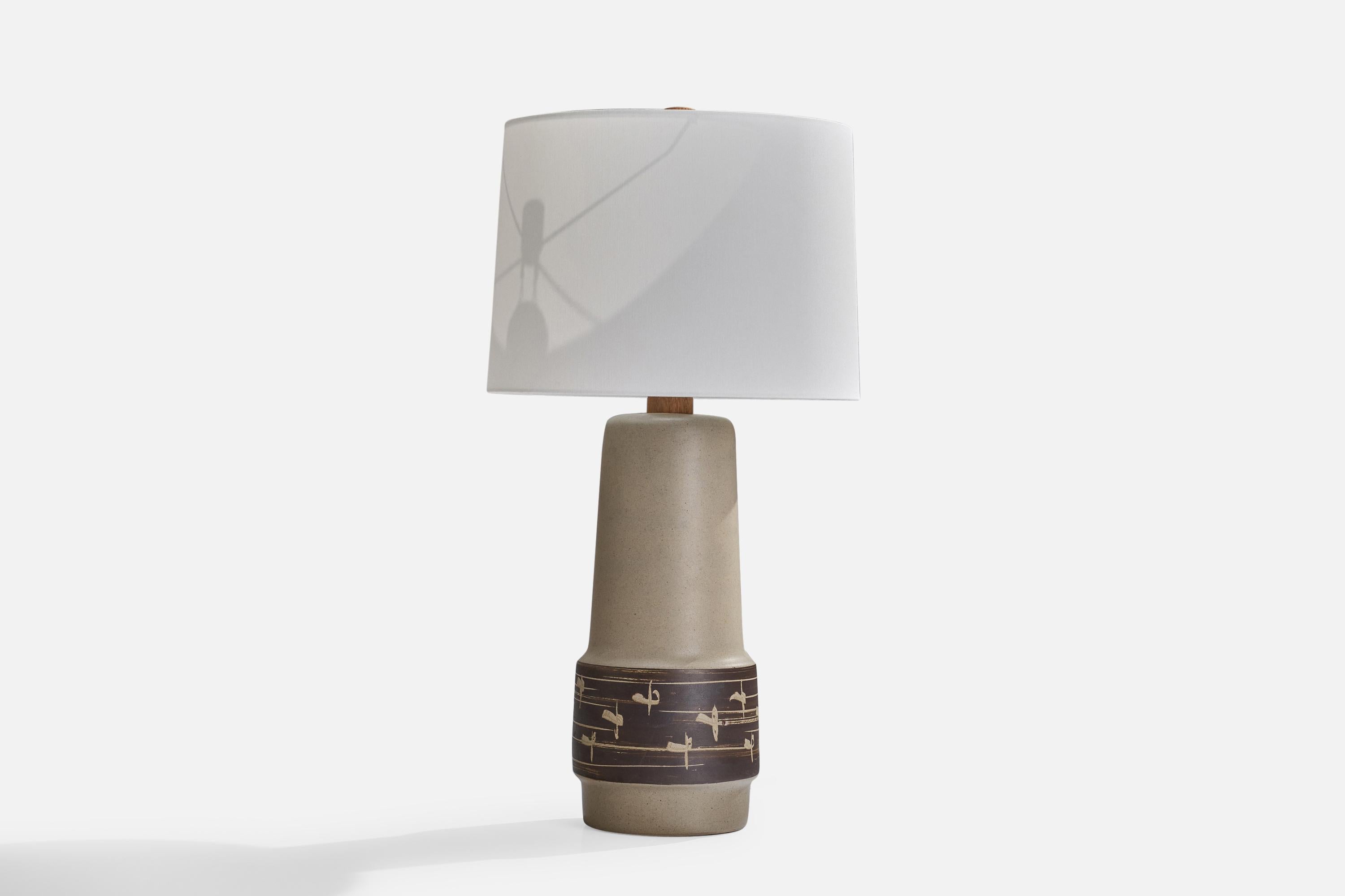 A grey-glazed and brown ceramic and walnut table lamp designed by Jane & Gordon Martz and produced by Marshall Studios, USA, 1960s.

Dimensions of Lamp (inches): 20.48”  H x 7.68”  Diameter
Dimensions of Shade (inches): 13” Top Diameter x 13.75”
