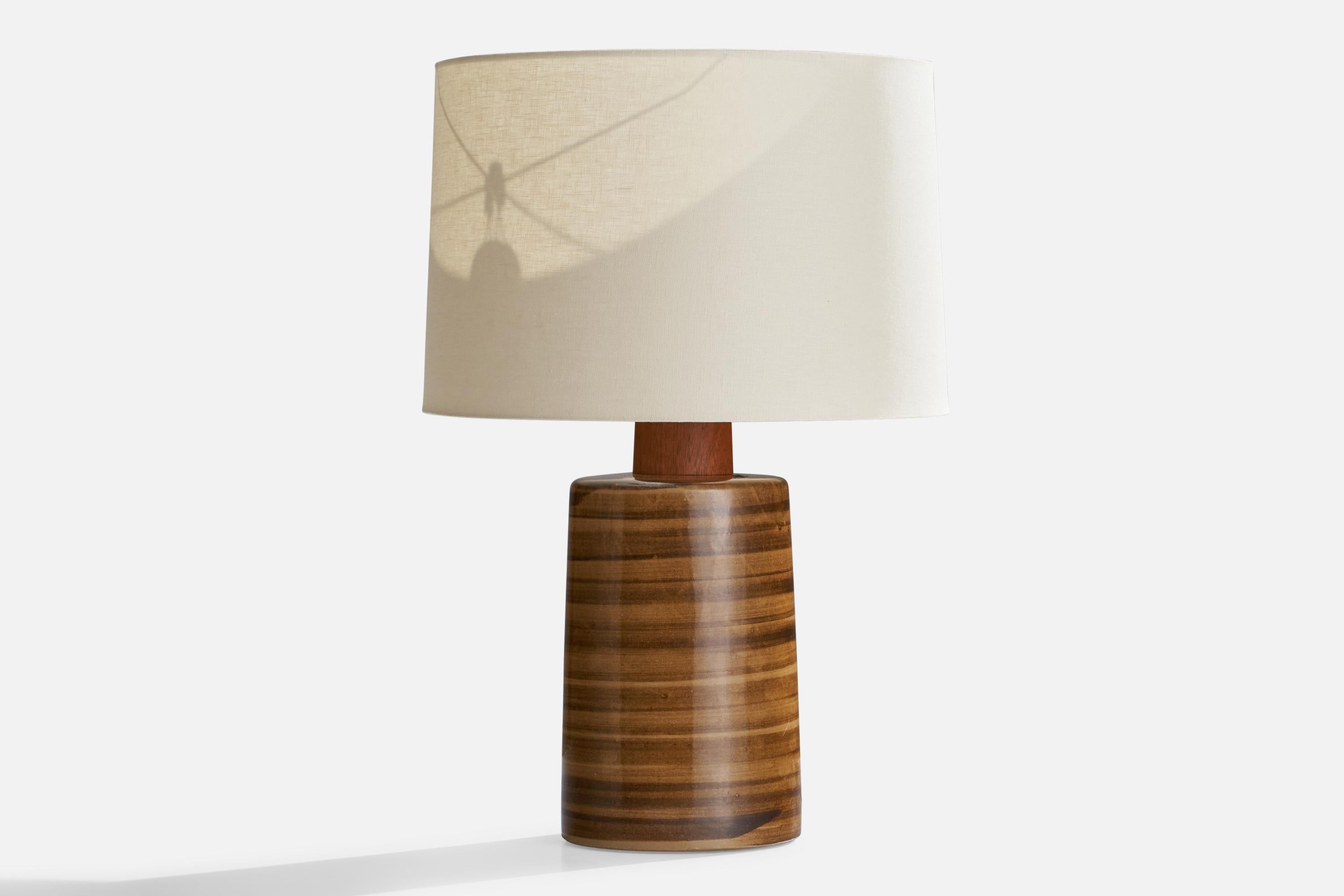 A brown and black-glazed ceramic and walnut table lamp designed by Jane & Gordon Martz and produced by Marshall Studios, USA, 1960s.

Overall Dimensions (inches): 21.5”  H x 8.25” D
Stated dimensions include shade.
Bulb Specifications: E-26