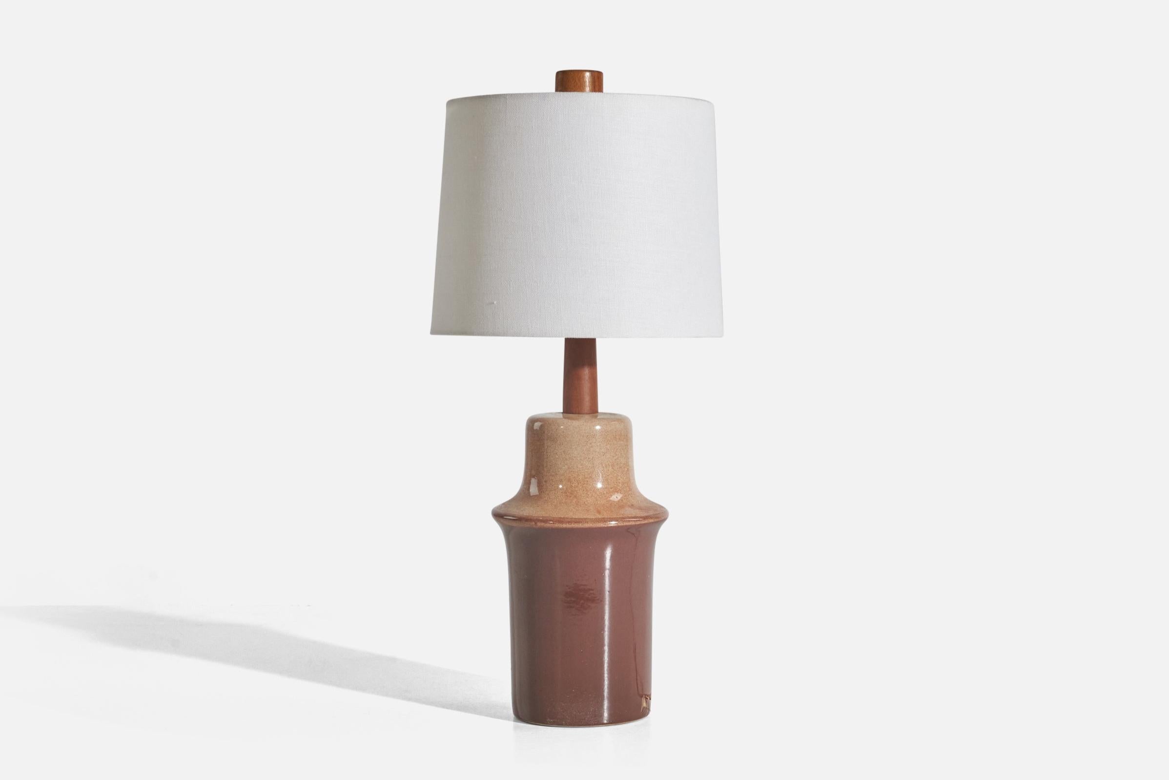 A brown and beige-glazed ceramic and walnut table lamp designed by Jane & Gordon Martz and produced by Marshall Studios, USA, 1960s.

Sold without Lampshade

Dimensions of Lamp (inches) : 16 x 6.18 x 6.18 (Height x Width x Depth)

Dimensions of