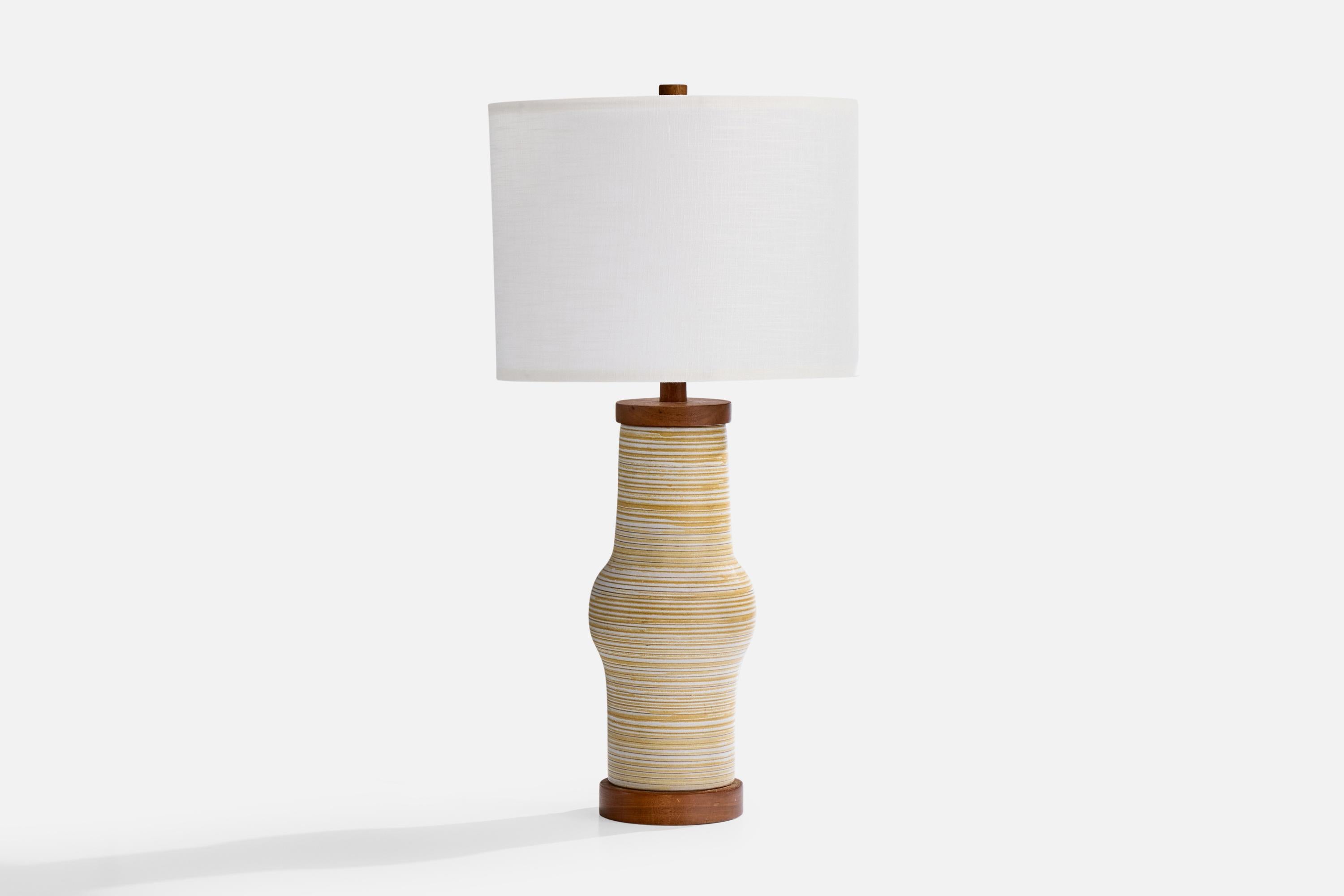 A yellow white-glazed ceramic and walnut table lamp designed by Jane & Gordon Martz and produced by Marshall Studios, USA, c. 1960s.

Wear consistent with age and use

Dimensions of Shade (inches): 16.5” Top Diameter x 16.5” Bottom Diameter x 12”
