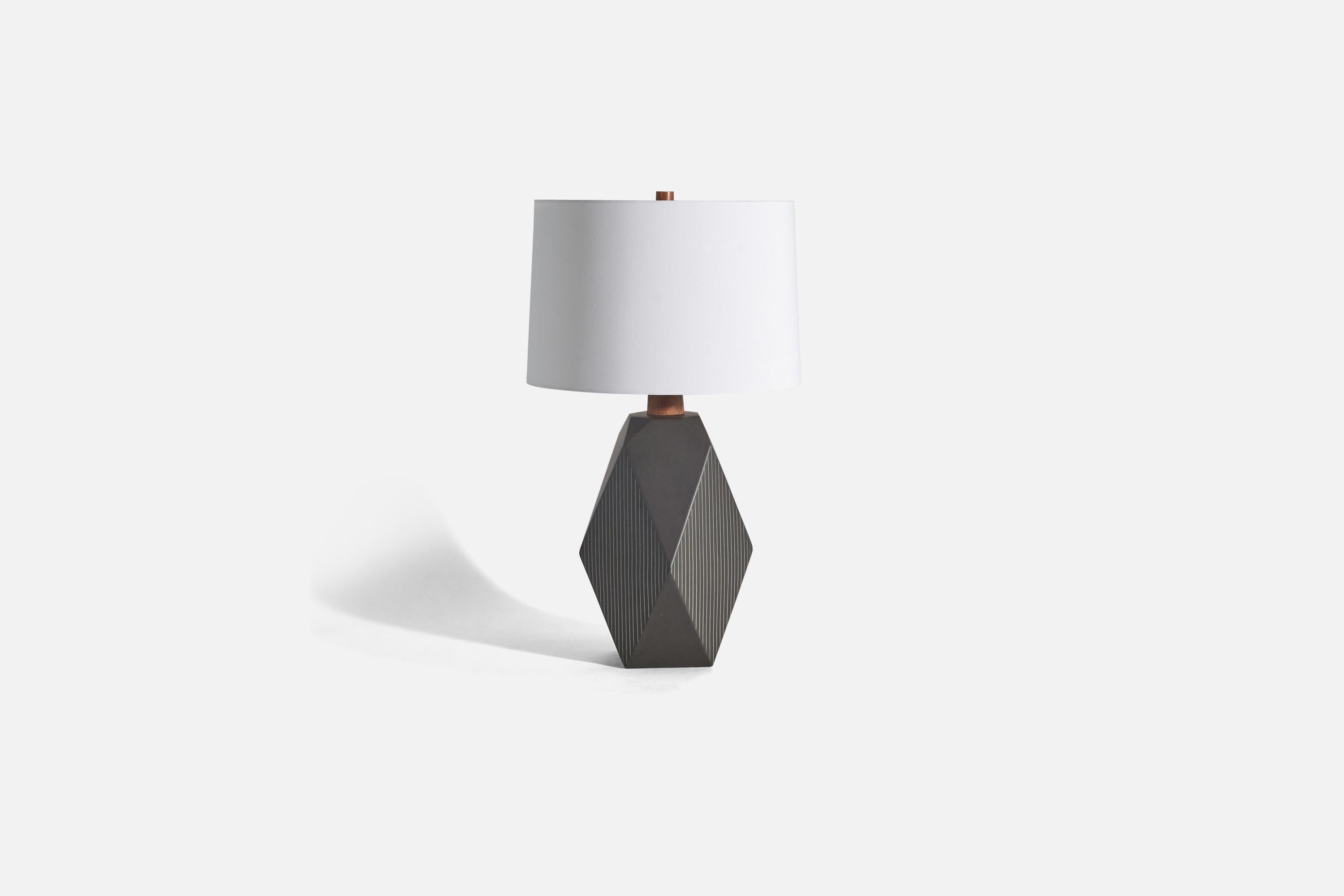 A black ceramic and wood table lamp designed by Jane & Gordon Martz and produced by Marshall Studios, Indianapolis, United States, 1960s.

Sold without lampshade(s)
Dimensions of lamp (inches) : 23.54 x 11.81 x 12 (height x width x