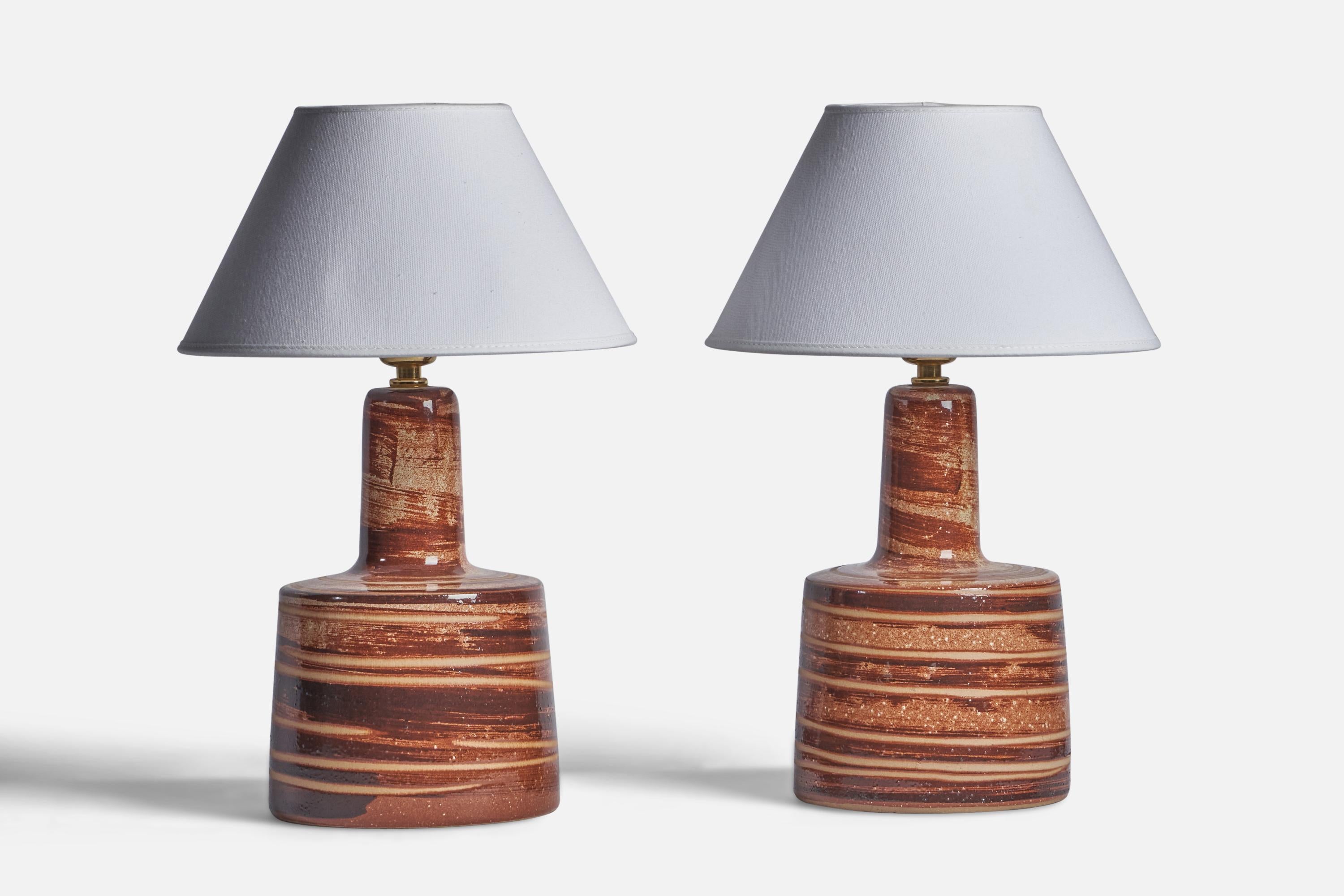 A pair of beige and brown-glazed ceramic table lamps designed by Jane & Gordon Martz and produced by Marshall Studios, USA, 1960s.

Dimensions of Lamp (inches): 12.15” H x 6.25” Diameter
Dimensions of Shade (inches): 4.5” Top Diameter x 10” Bottom