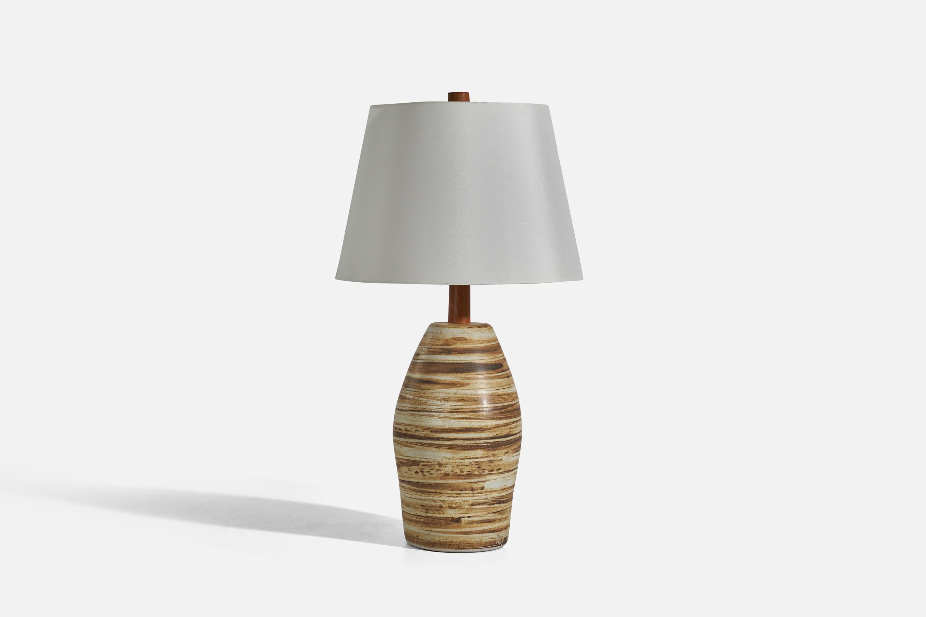 A pair of walnut and beige and brown hand-painted ceramic table lamps designed by Jane & Gordon Martz and produced by Marshall Studios, Indianapolis, c. 1960s. 

Sold without Lampshades.

Dimensions of Lamp (inches) : 18.37 x 7.37 x 7.37 (Height x