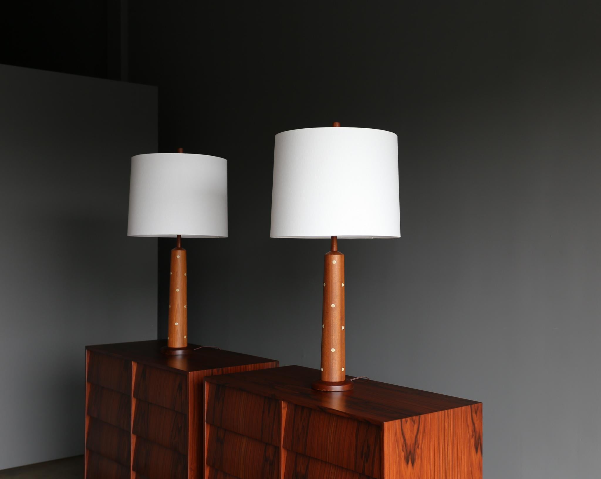 Jane & Gordon Martz walnut and ceramic tile lamps for Marshall Studios, circa 1960. This pair has been professionally rewired. Each Lamp retains its original finial. The lamp shades are not included in the purchase.
