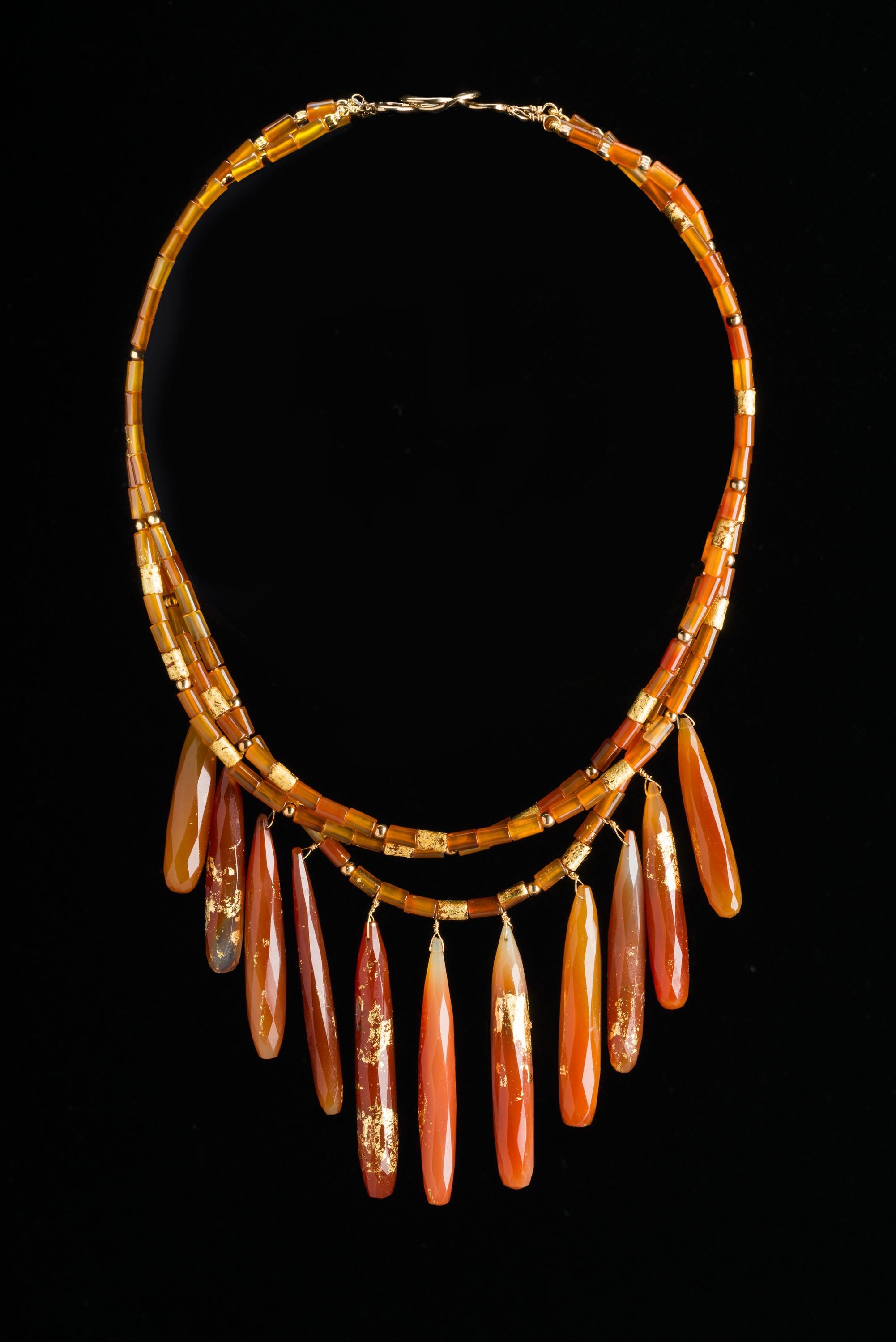 Jane Magon Collections Three Strands of Carnelian Gemstone Drop Necklace from the “Day to Night Collection”. Faceted Carnelian Beads with 22kt Gold Leaf Hand-Painted on with an 18 Karat Gold Figure Eight Clasp, Wire, and Beads. 
It comes in a Jane