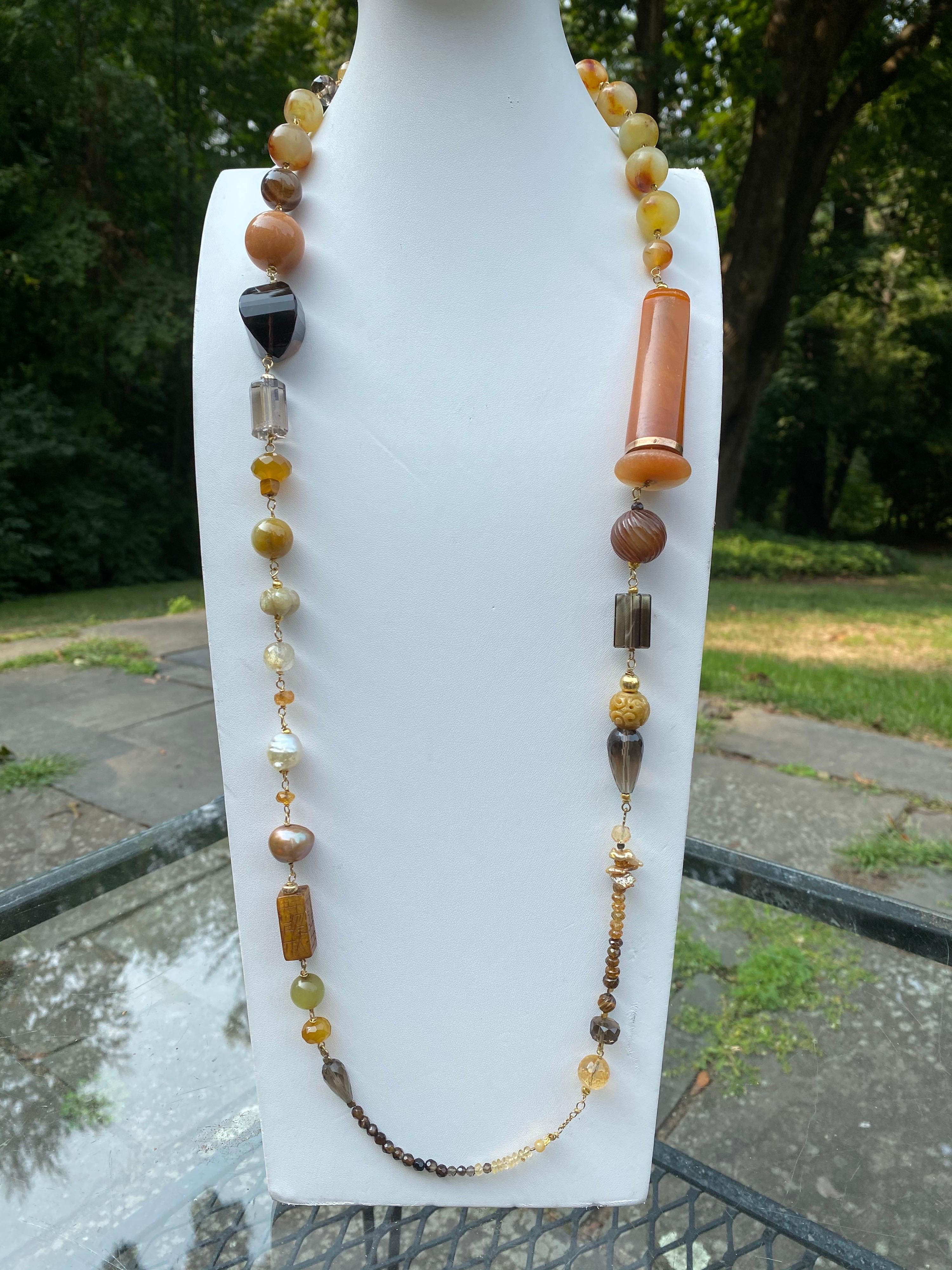 This is a one of a kind necklace by the award-winning design Jane Magon Collections, It consists of Handcarved Burmese Jade, Honey Jade, South Sea Pearls, Faceted Smokey Quartz, Mexican Fire Opal, Citrines, Agates, and a Vintage Amber Cigarette