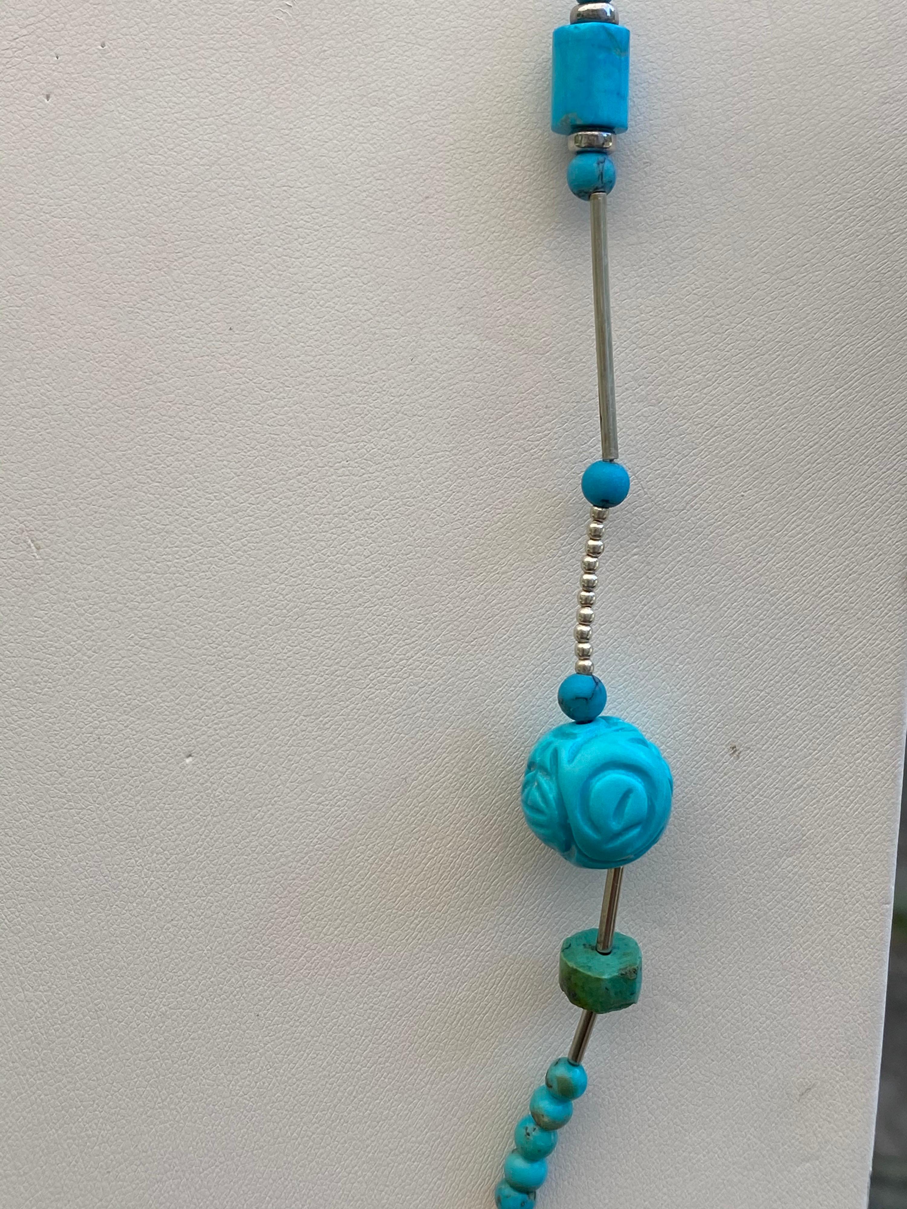 This is a lightweight easy to wear necklace that has carved Turquoise, a variety of Turquoise Beads/Rondelles, and Matrix Turquoise in it. It's surrounded by a mixture of beads of Sterling Silver and measures 31 inches in length with a large lobster
