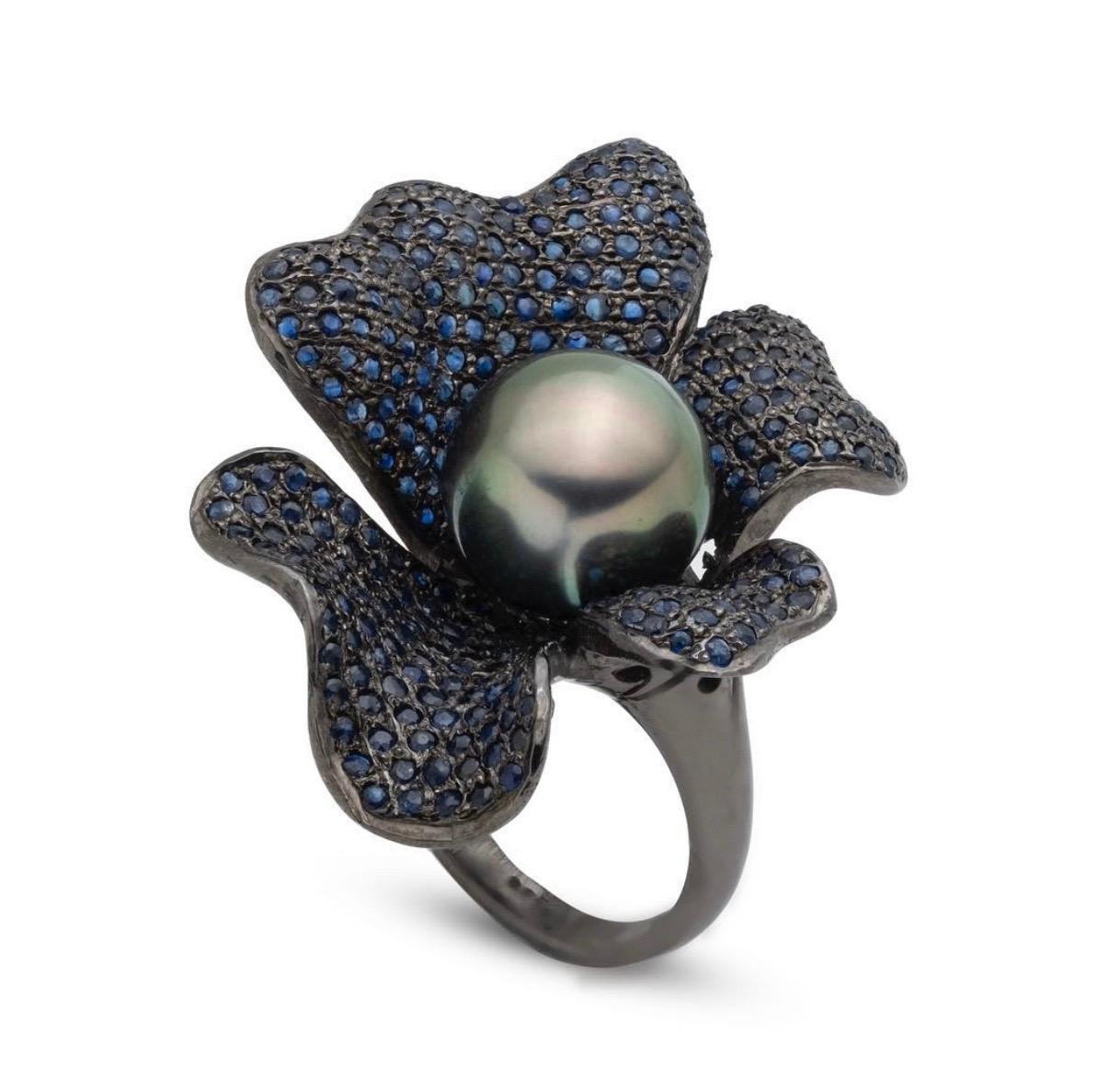 Jane Magon Collections Tahitian Pearl and Pave Blue Sapphire Ring set in Black Rhodium Sterling Silver. The Tahitian Pearl measures 11mm and is Fine Quality with a Green and Rose Overtone, no blemishes. The Sapphire weights are approximately 2.00ct