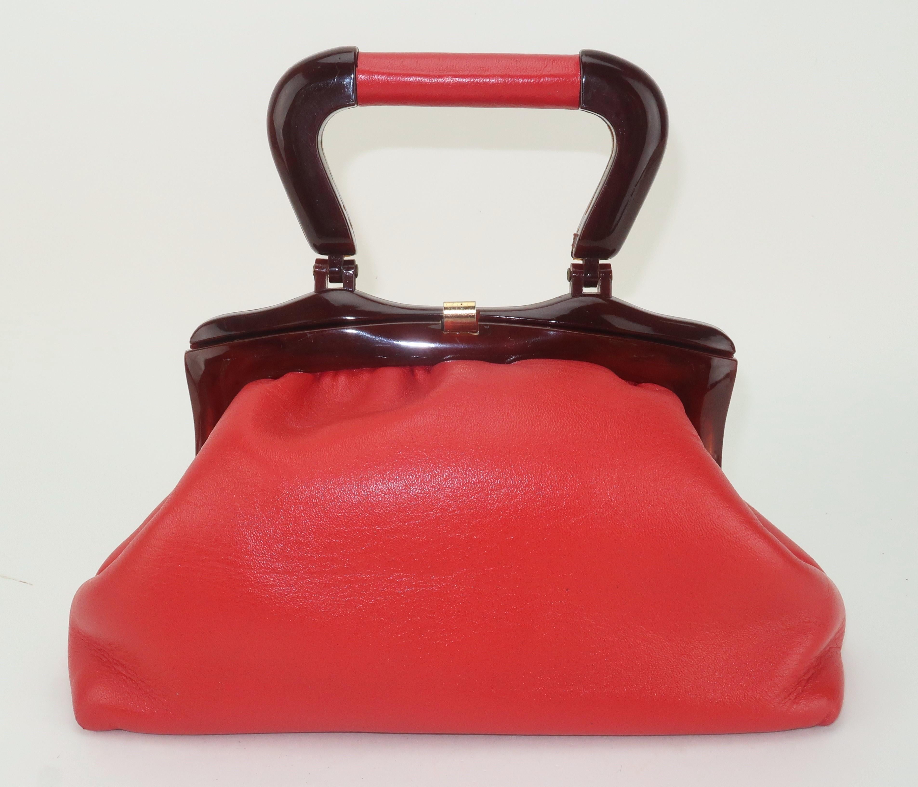 Swing into the 1960’s with a Jane Shilton handbag in red leather with a faux tortoise resin top handle.  Alexander Shilton started his handbag company in London creating classic leather designs for the English market.  He left his company in the