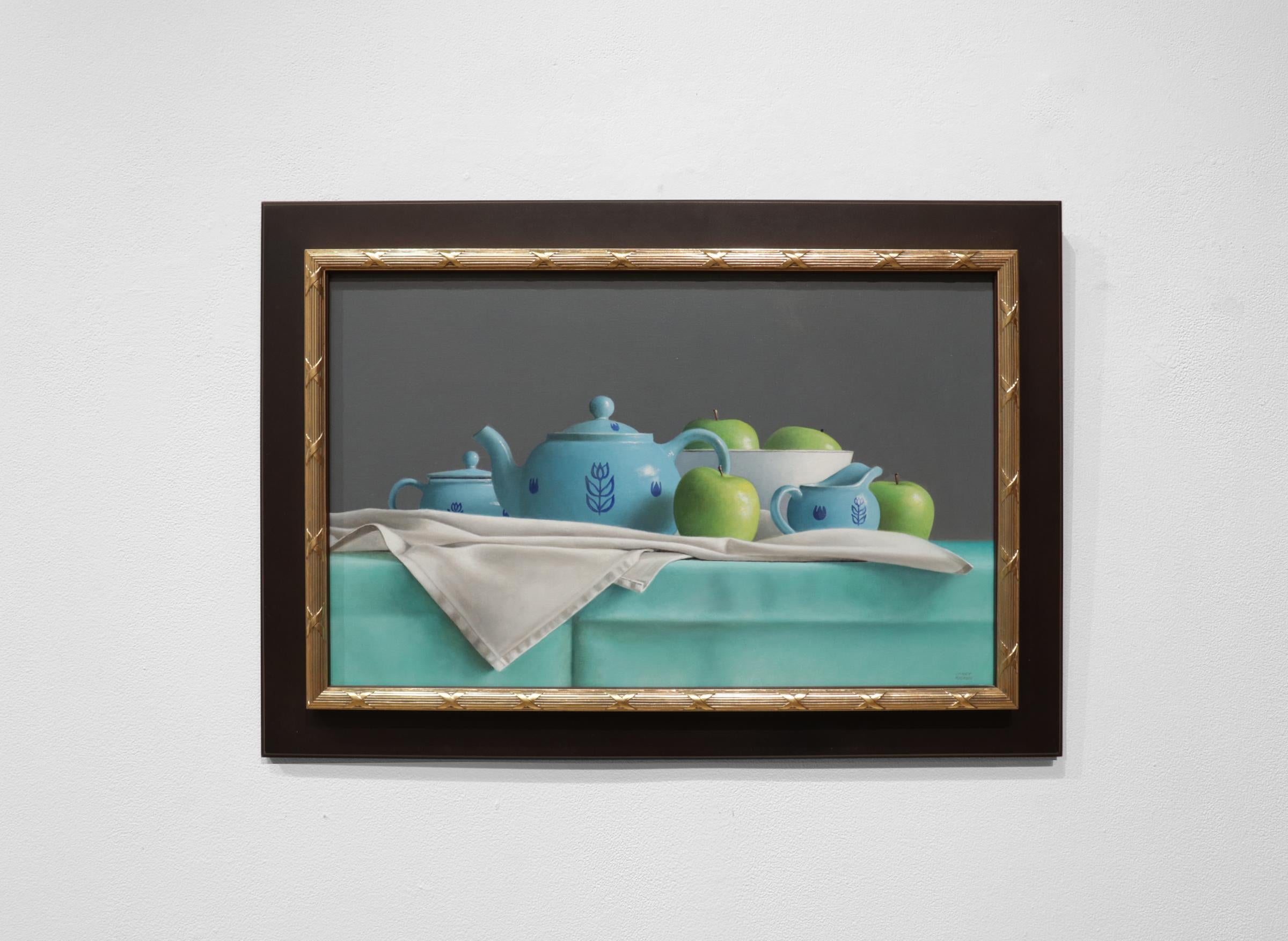 BLUE TEA SET AND GREEN APPLES, photo-realism, still life, bright blue, green - Painting by Janet Rickus