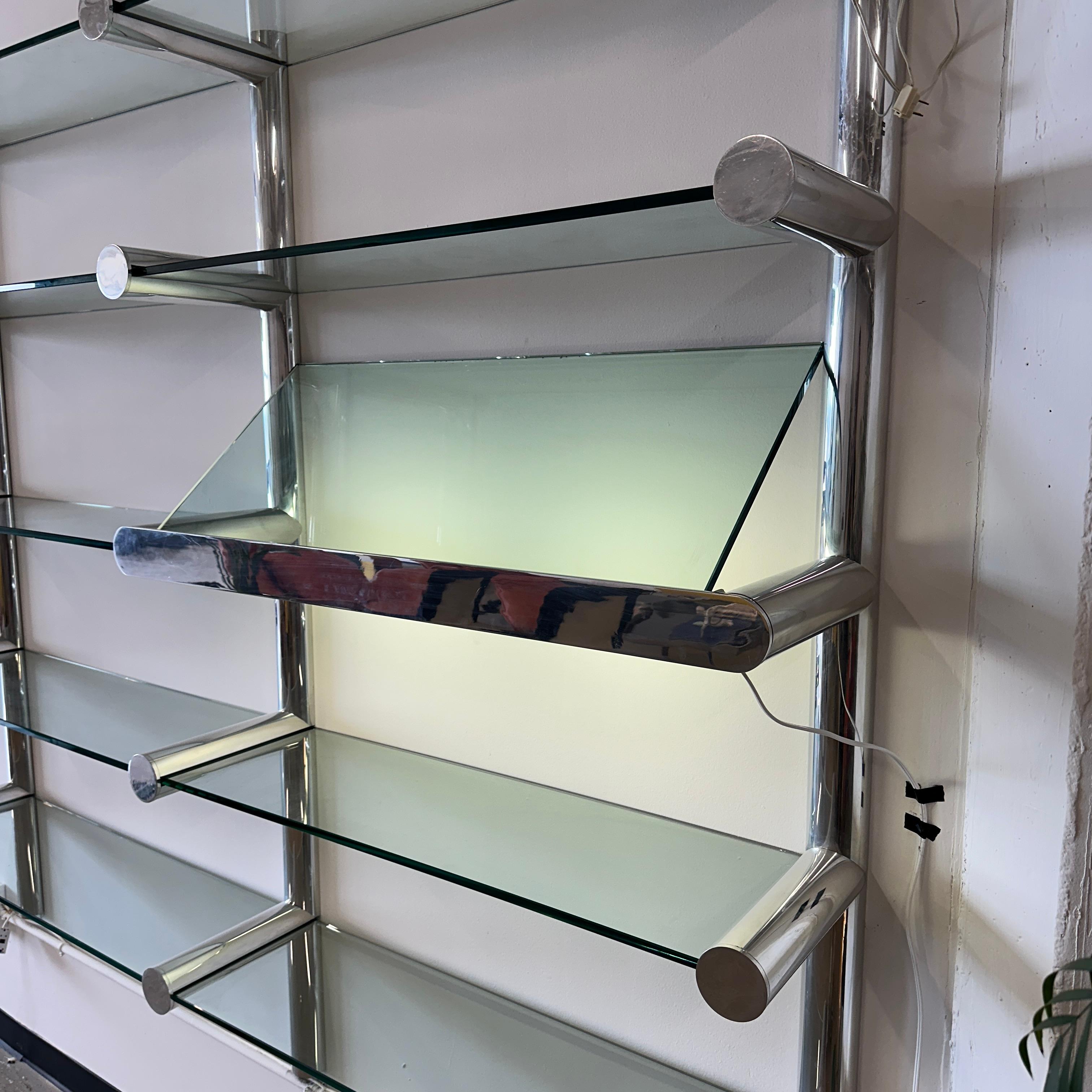c. 1970s featuring an illuminated display shelf. This piece is in great vintage condition but has scuffs, scratches, etc. There are also some chips missing on the glass but they are fully hidden when the unit is assembled since the chipped pieces